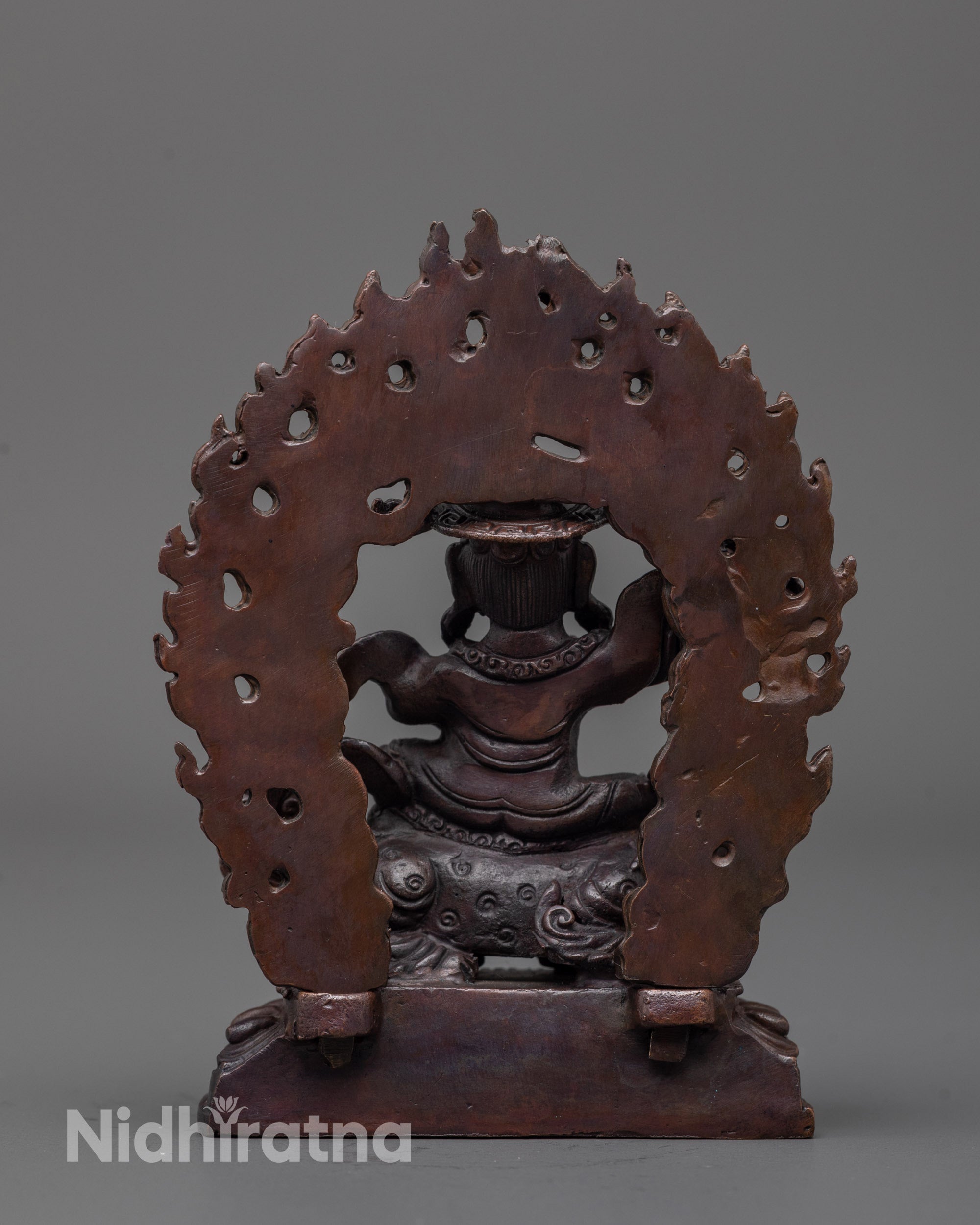 Back view of oxidized Dorje Lekpa statue highlighting detailed robes and sacred artistry