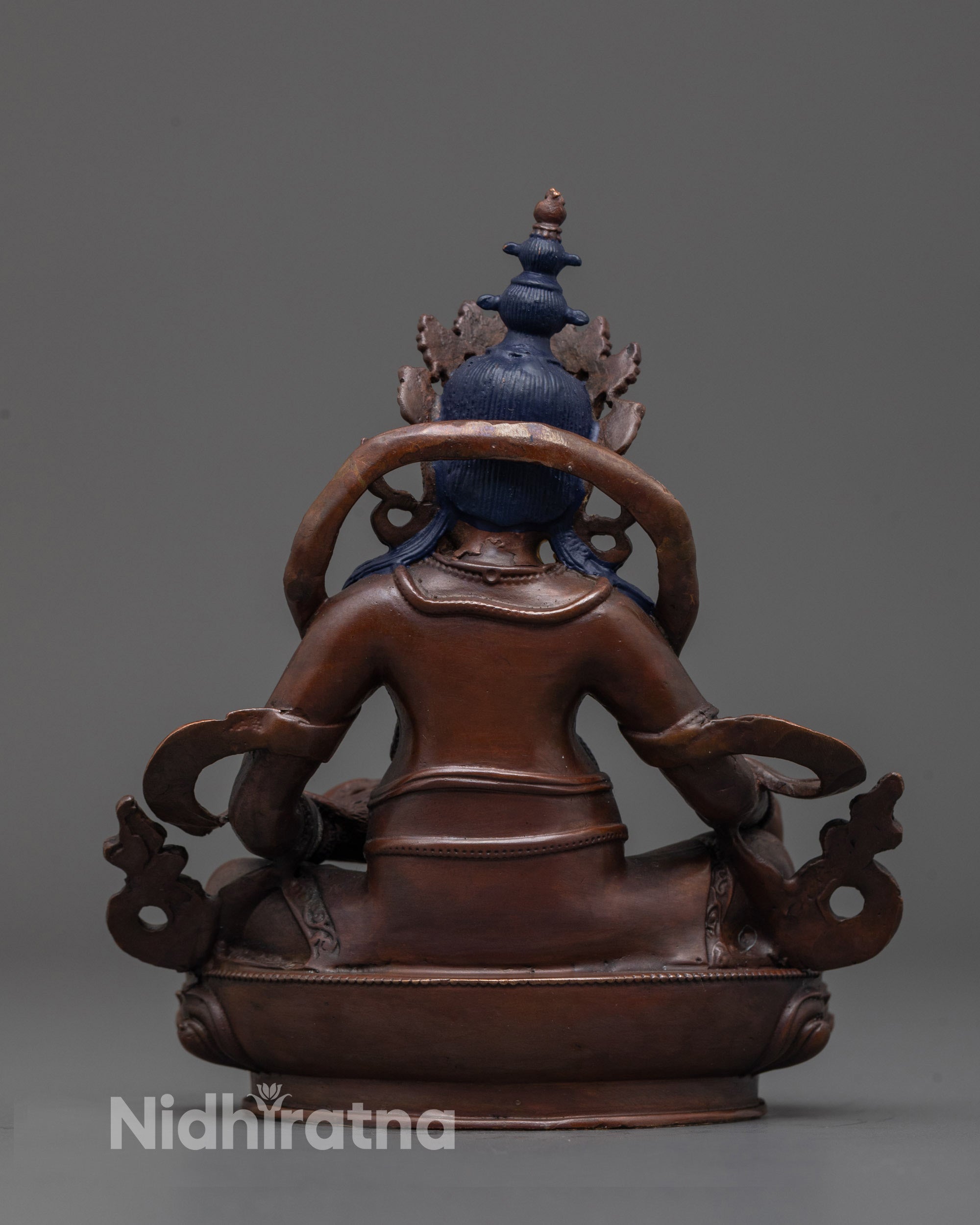 Back view of oxidized Dzambhala statue highlighting detailed craftsmanship and design