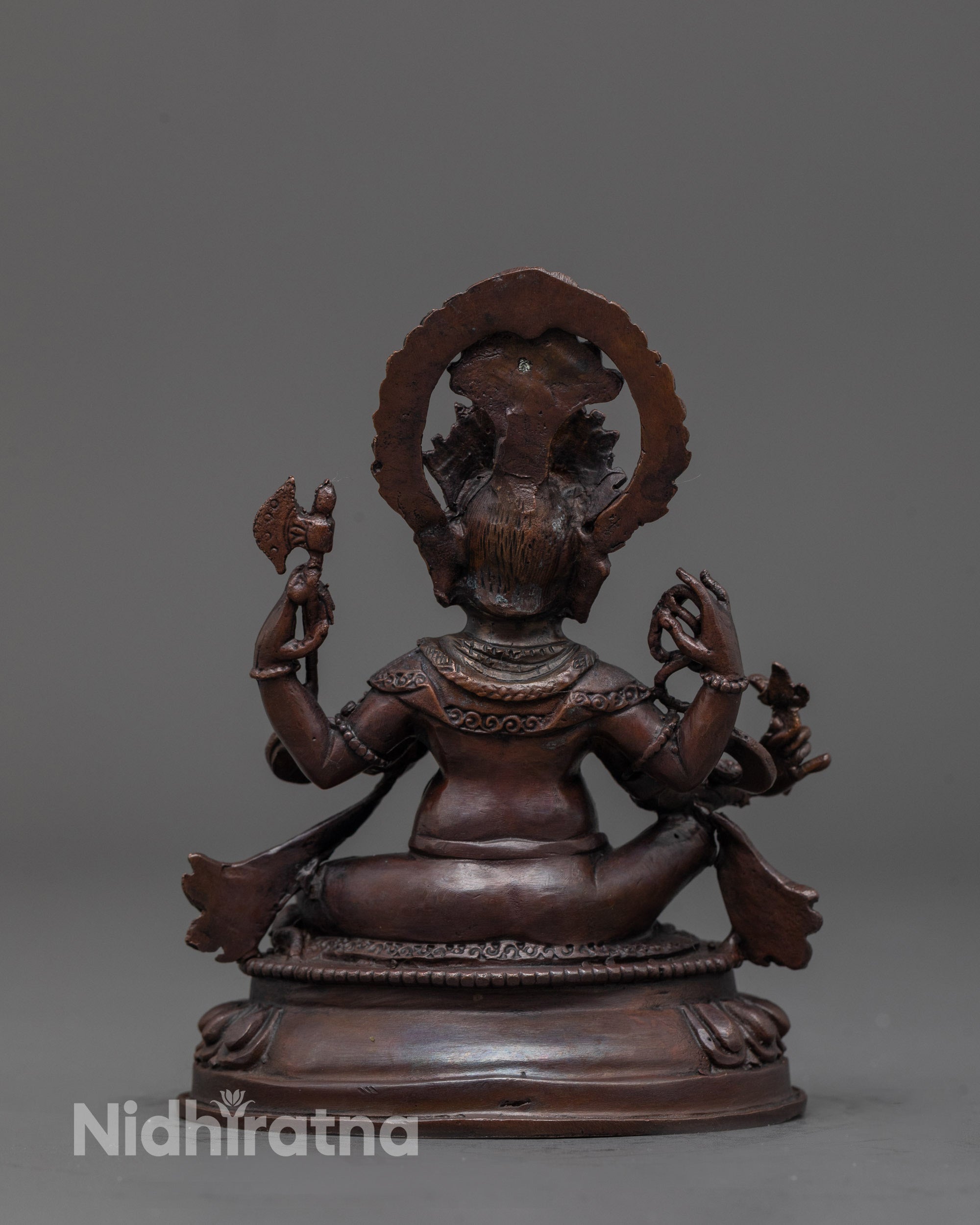 Back view of oxidized Ganesha statue showing fine detailing and copper finish