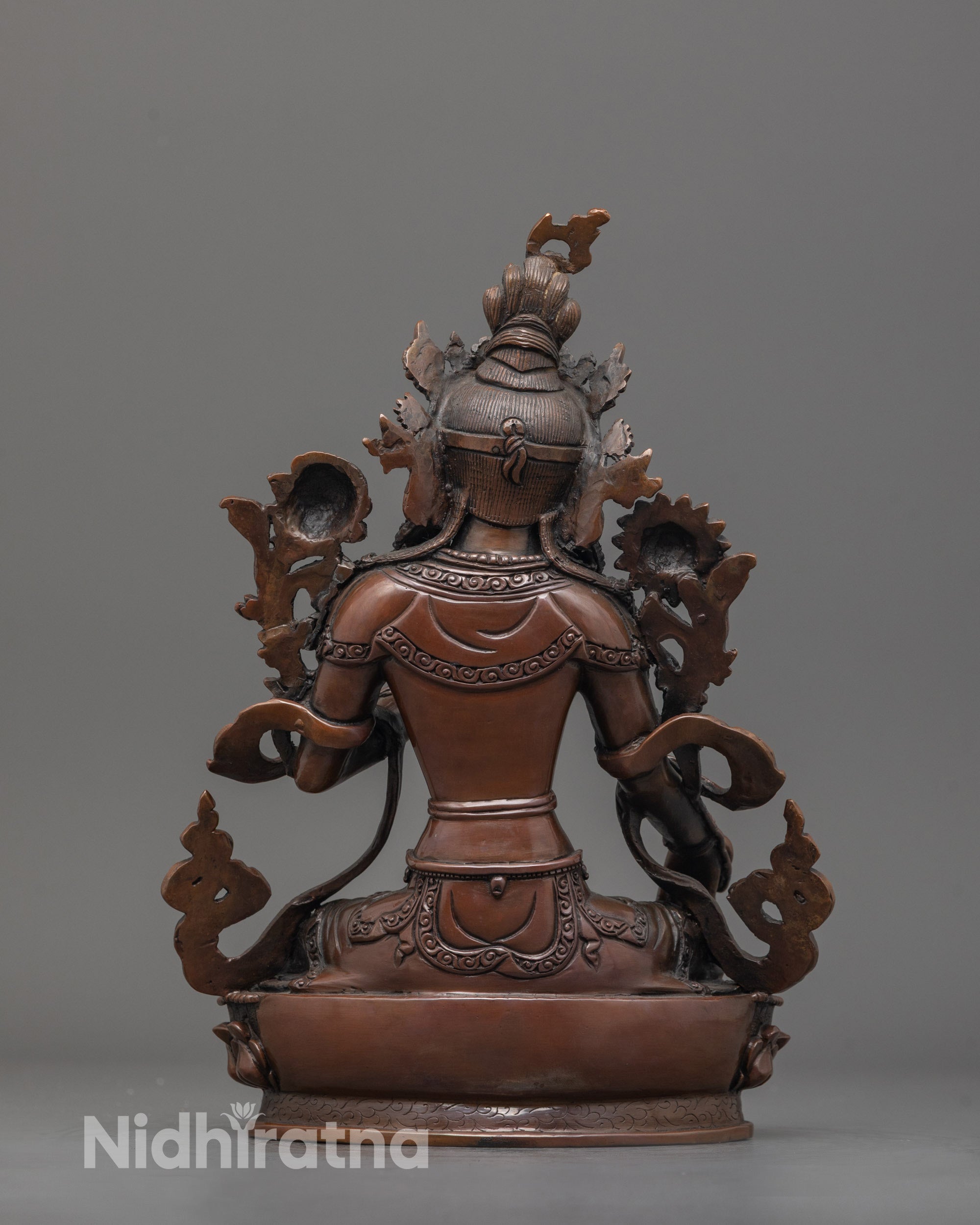 Back view of oxidized White Tara statue highlighting detailed patterns on lower garments