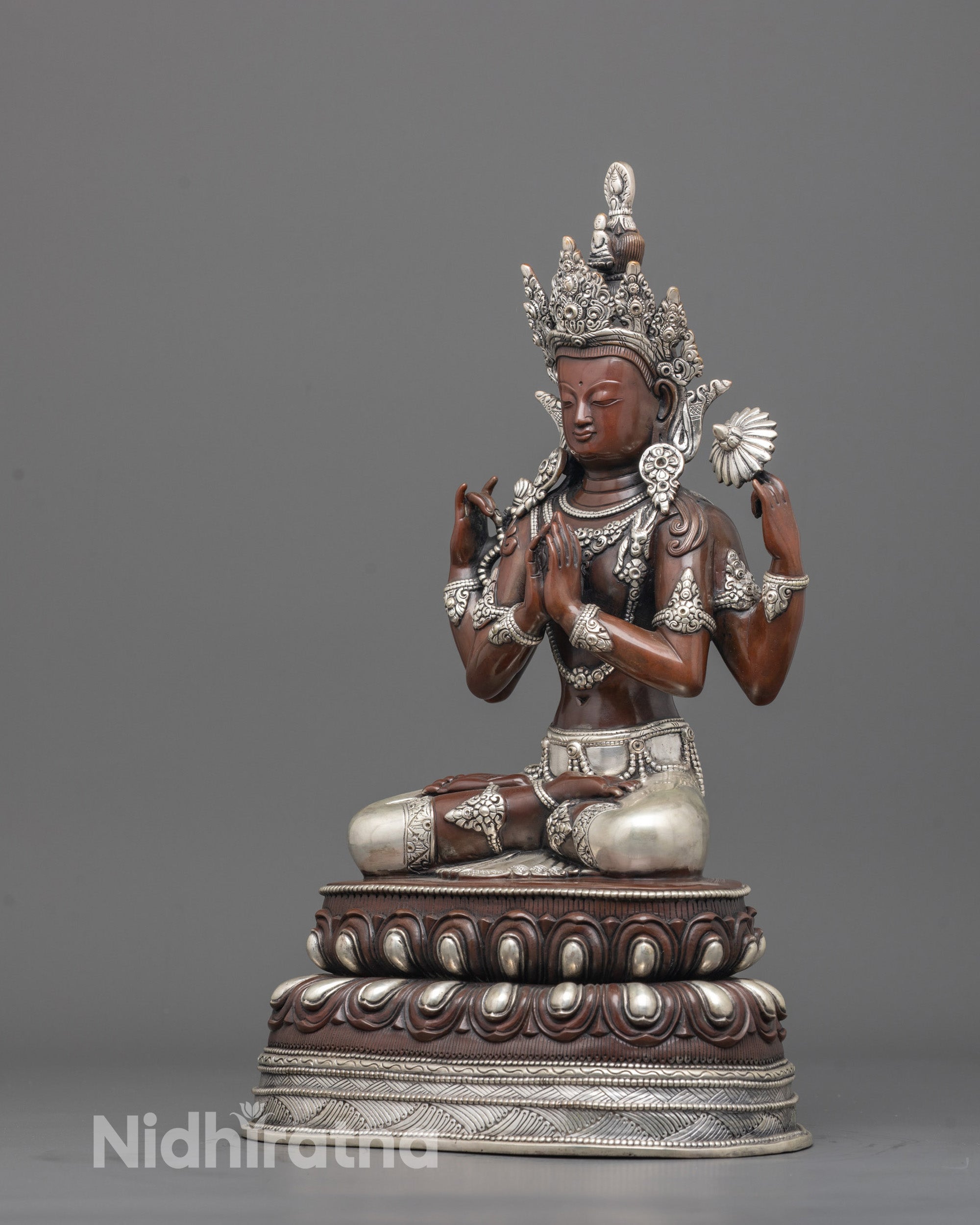 Back view of oxidized copper Chenrezig statue highlighting silver-plated garments and texture