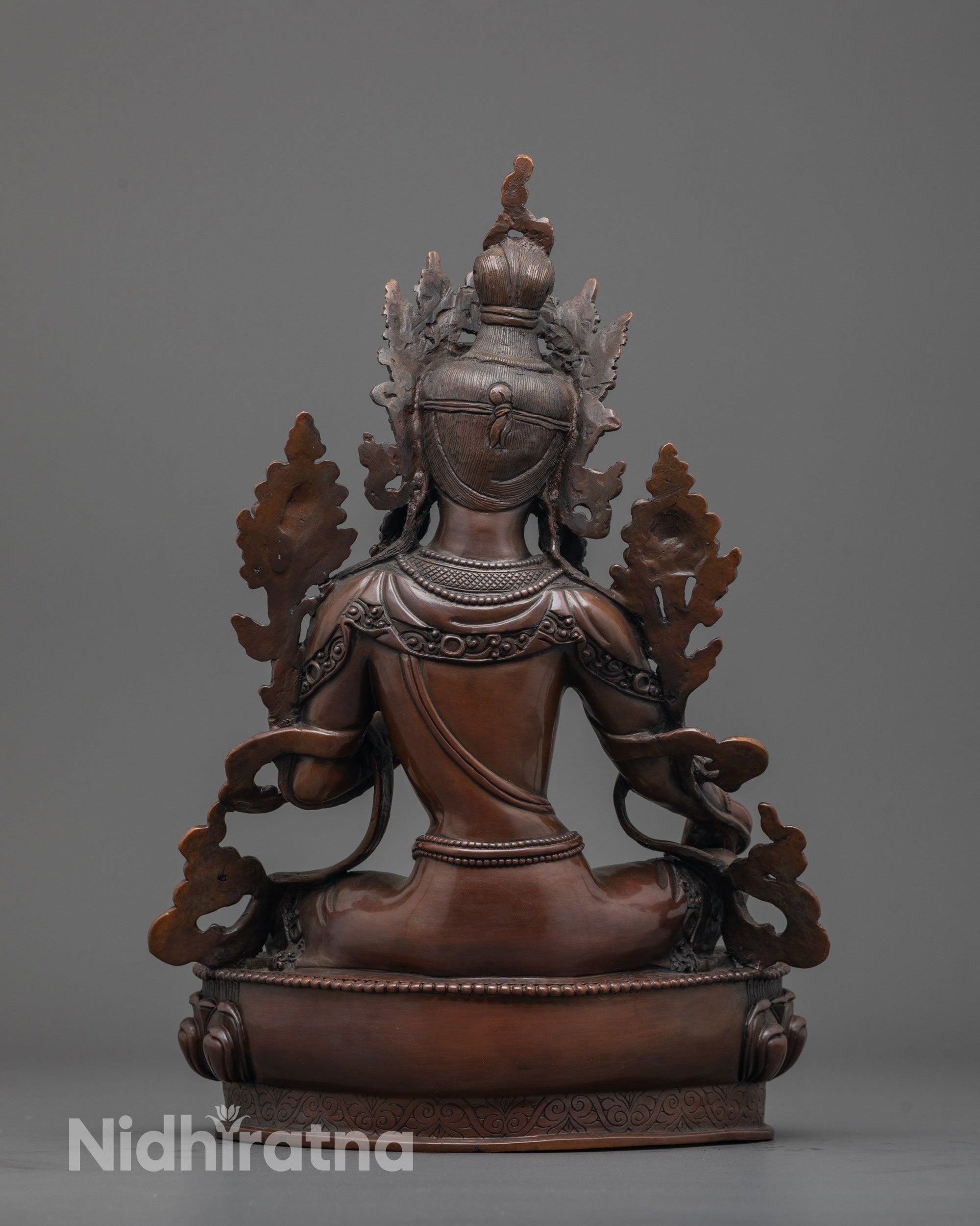 Back view of oxidized copper Green Tara statue showing detailed patterned robe craftsmanship.