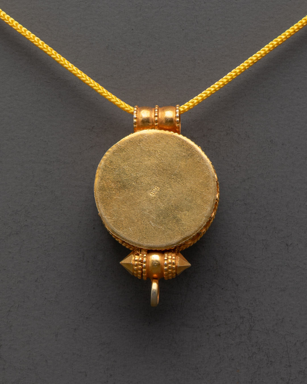 Back view of premium gold-gilded Bumpa Tibetan Locket by master artisans from Patan
