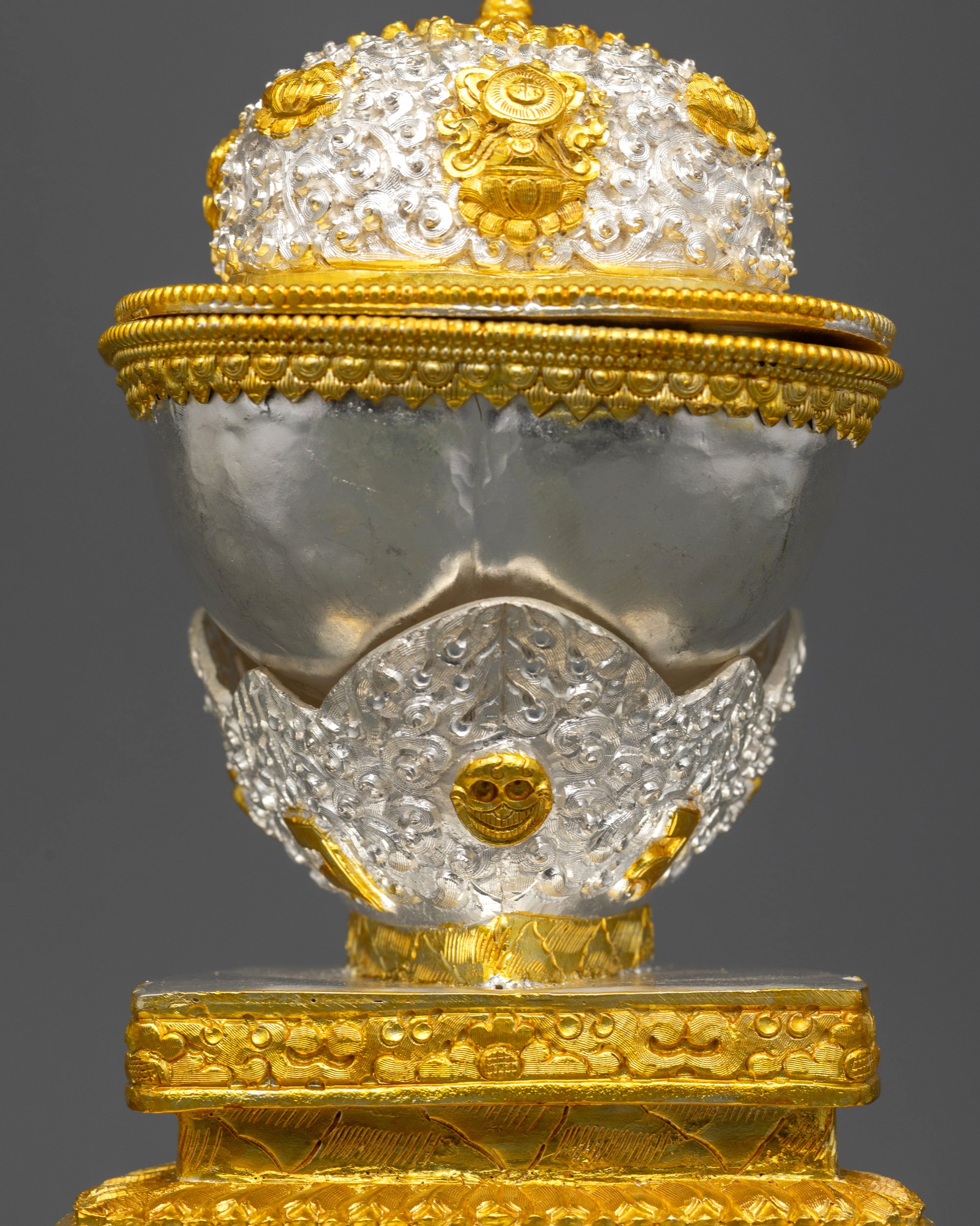 Back view of silver and gold Kapala featuring intricate filigree patterns and carvings