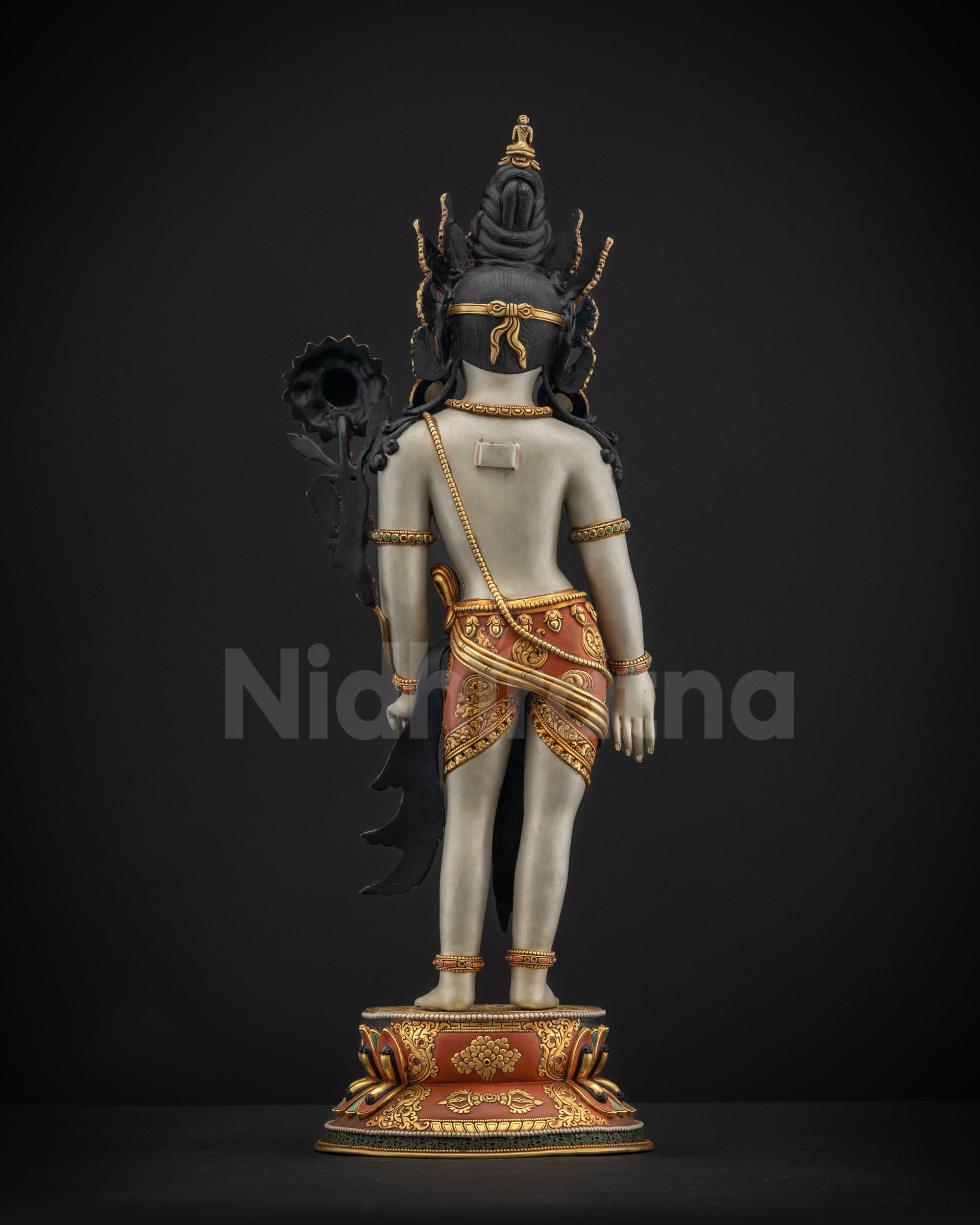 Back view of standing Padmapani showing intricate hand-carved motifs on lower garment