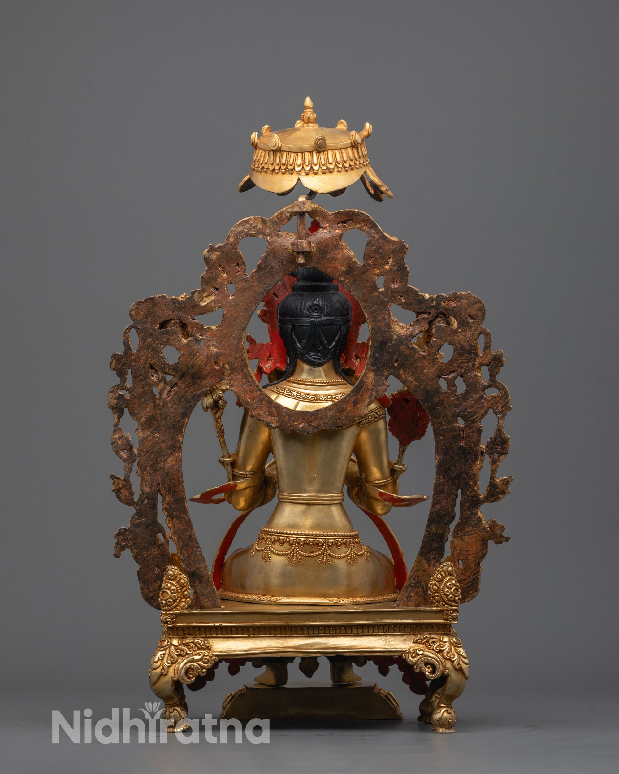 Back view of the Maitreya Buddha Statue revealing detailed throne carvings