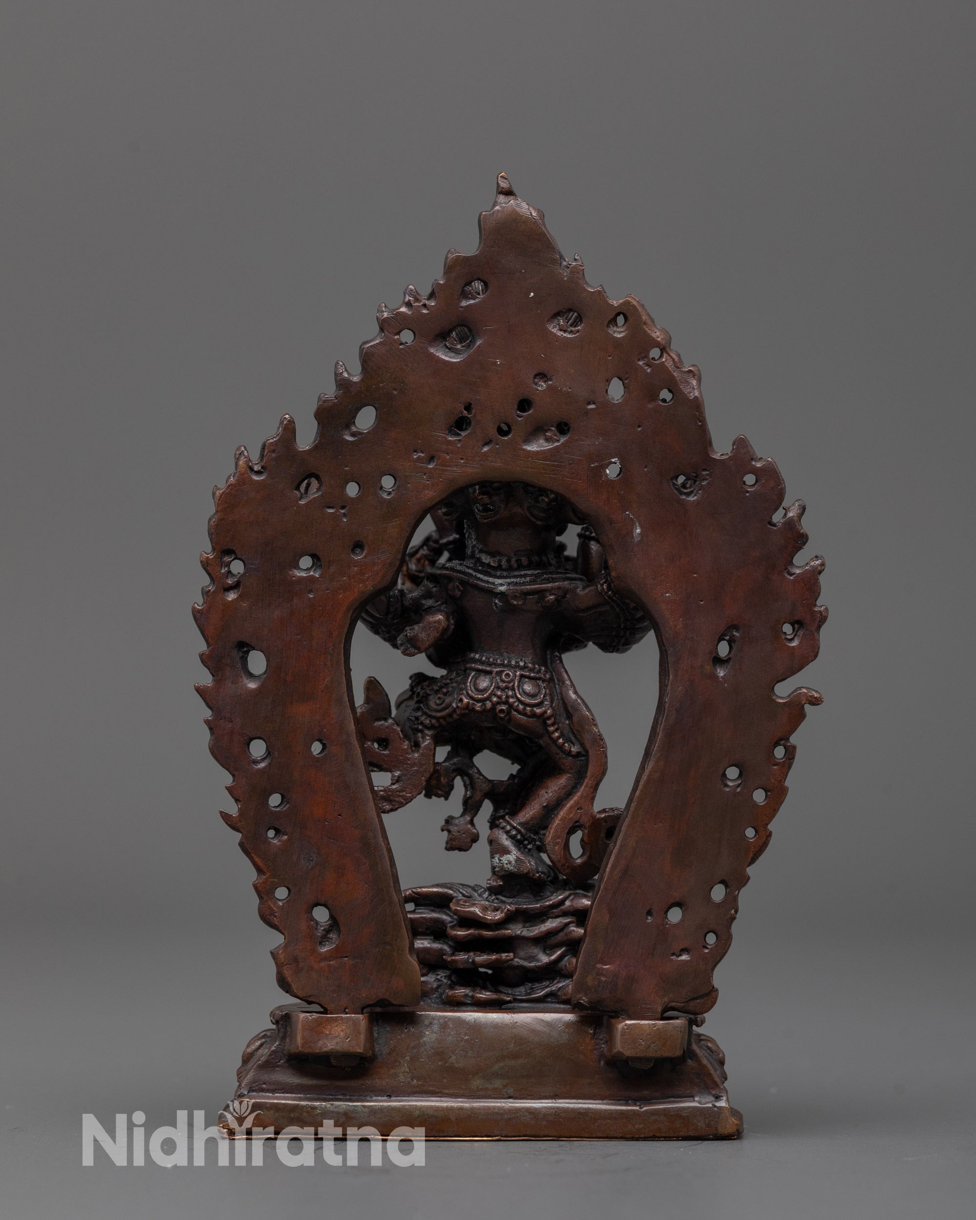 Back view of the oxidized copper Hevajra sculpture featuring flame-like details
