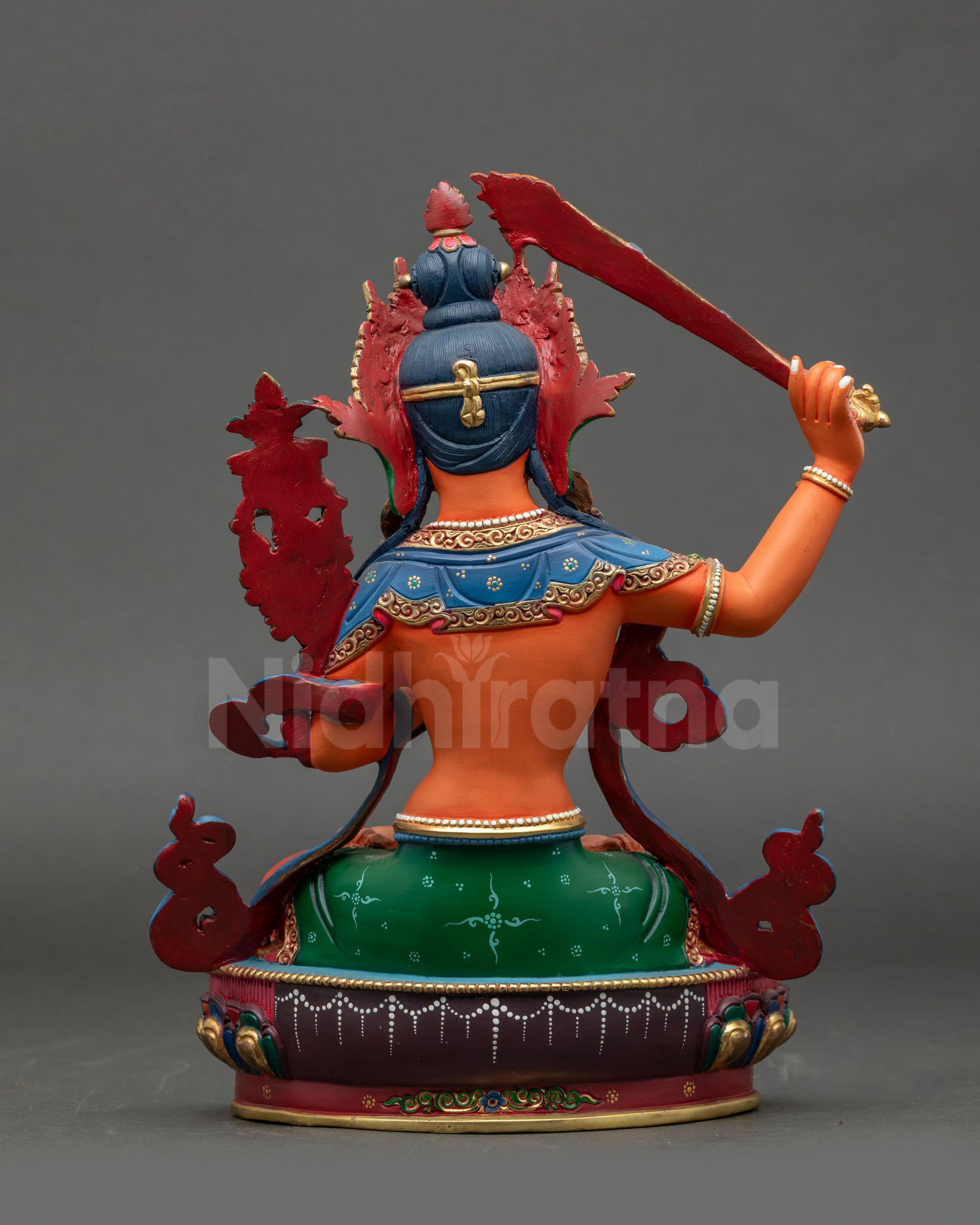 Back view of traditional Nepalese Manjushri statue highlighting detailed acrylic painting