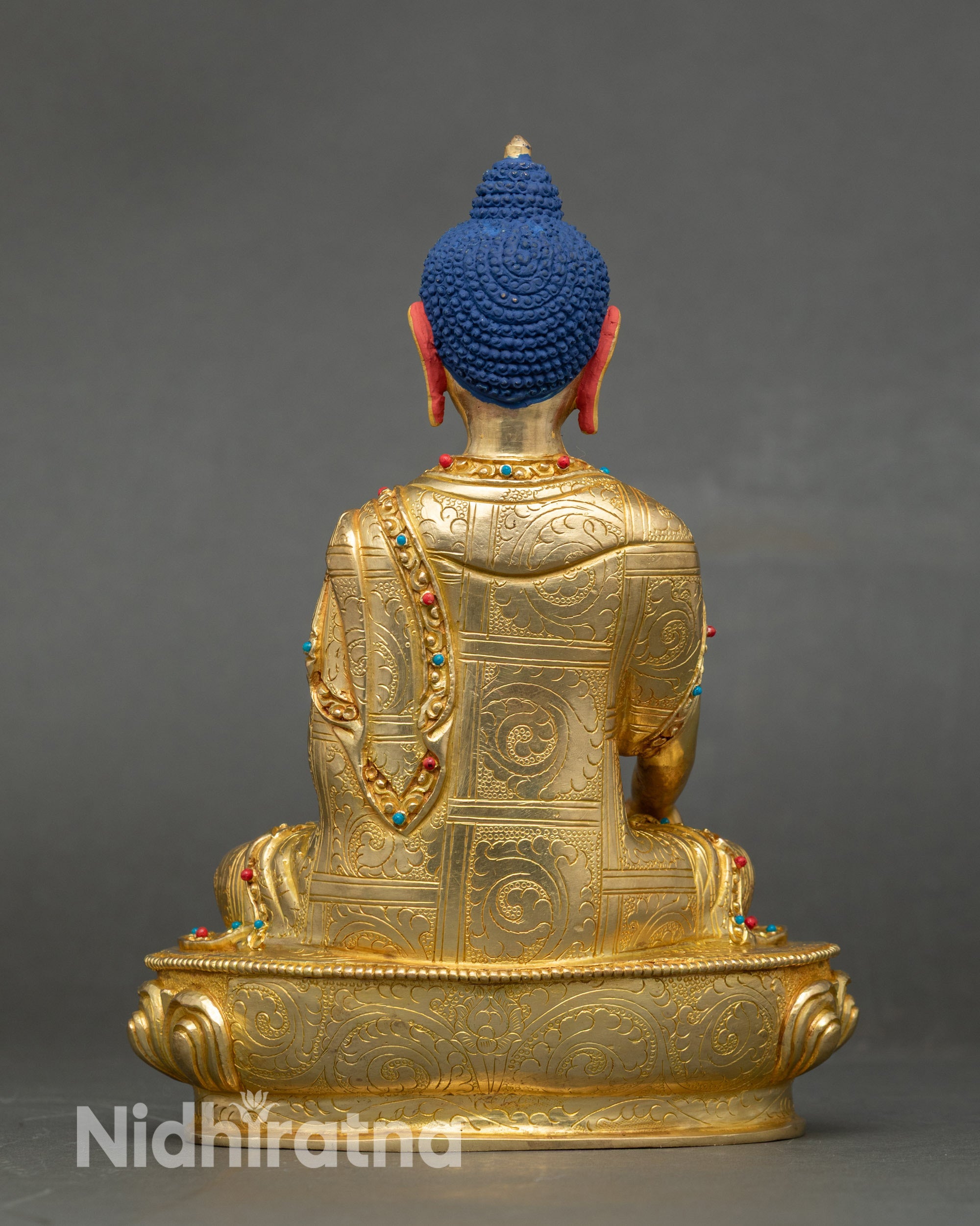 Back view pure gold Buddha statue handmade by Newari artisans with lotus throne and stone accents