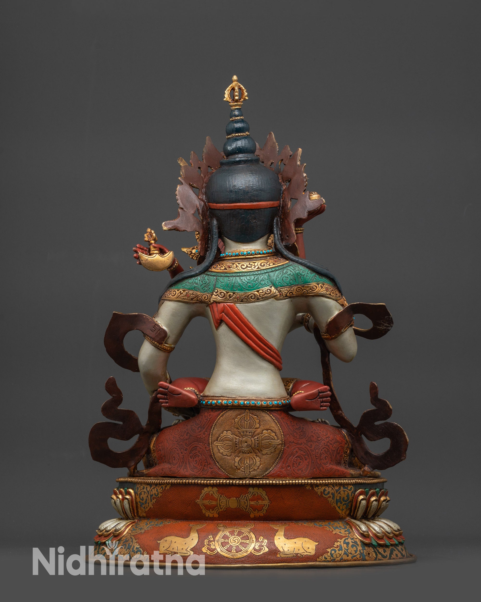 Back view showing intricate lotus seat carvings with dharma wheel and deer