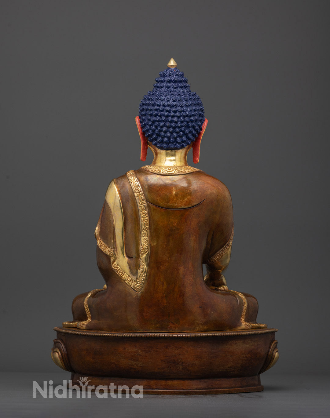 Back view showing robe details and hollow base of Buddha Shakyamuni statue