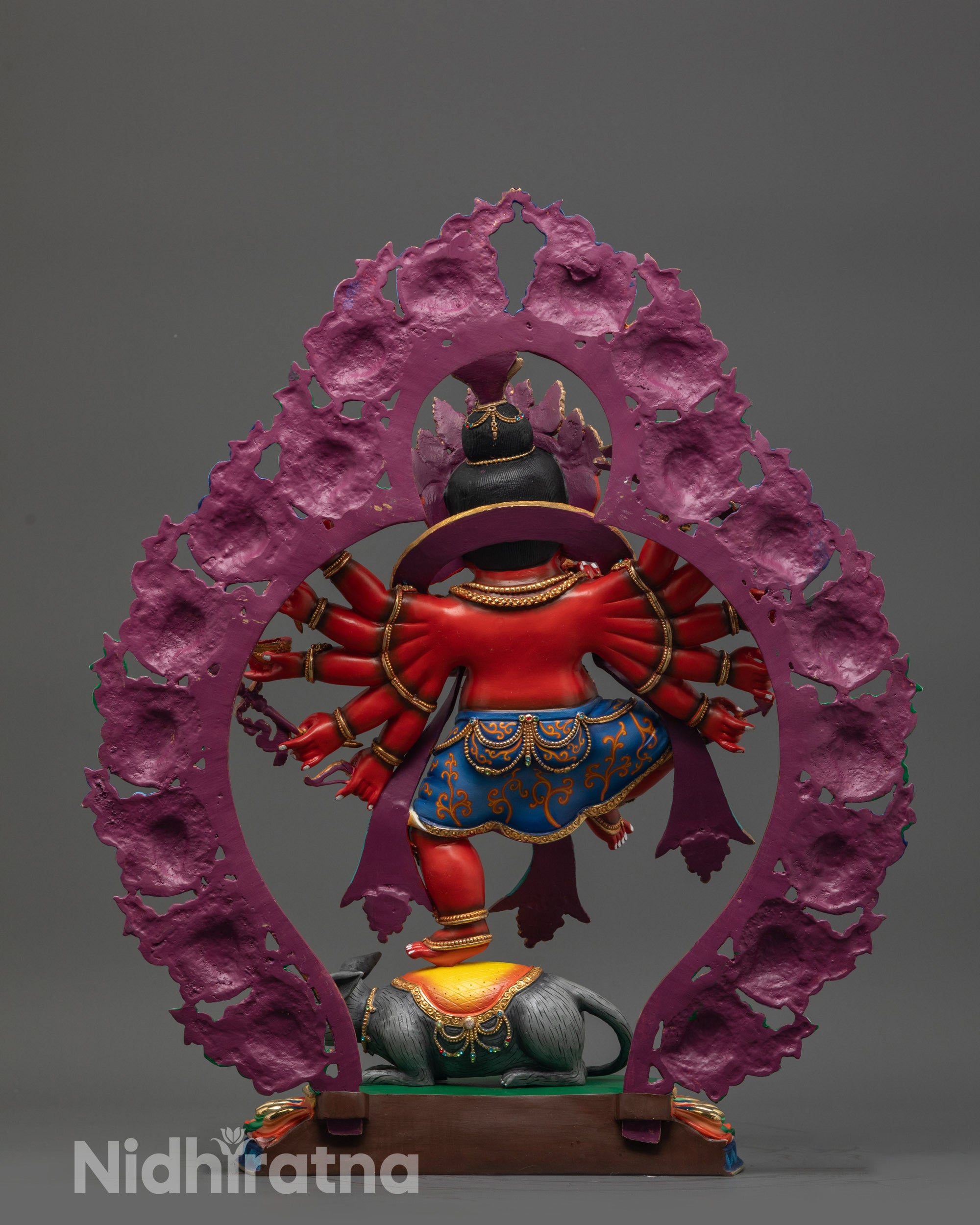Back view standing Ganesh statue with detailed multicoloured halo and lotus base