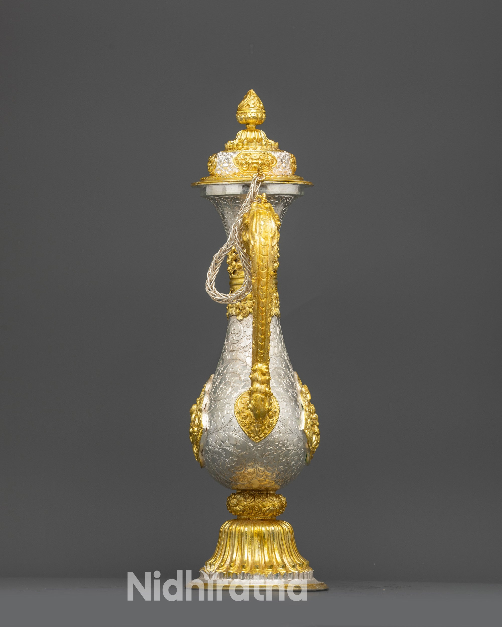 Back view traditional Himalayan ritual tea pot with floral engravings