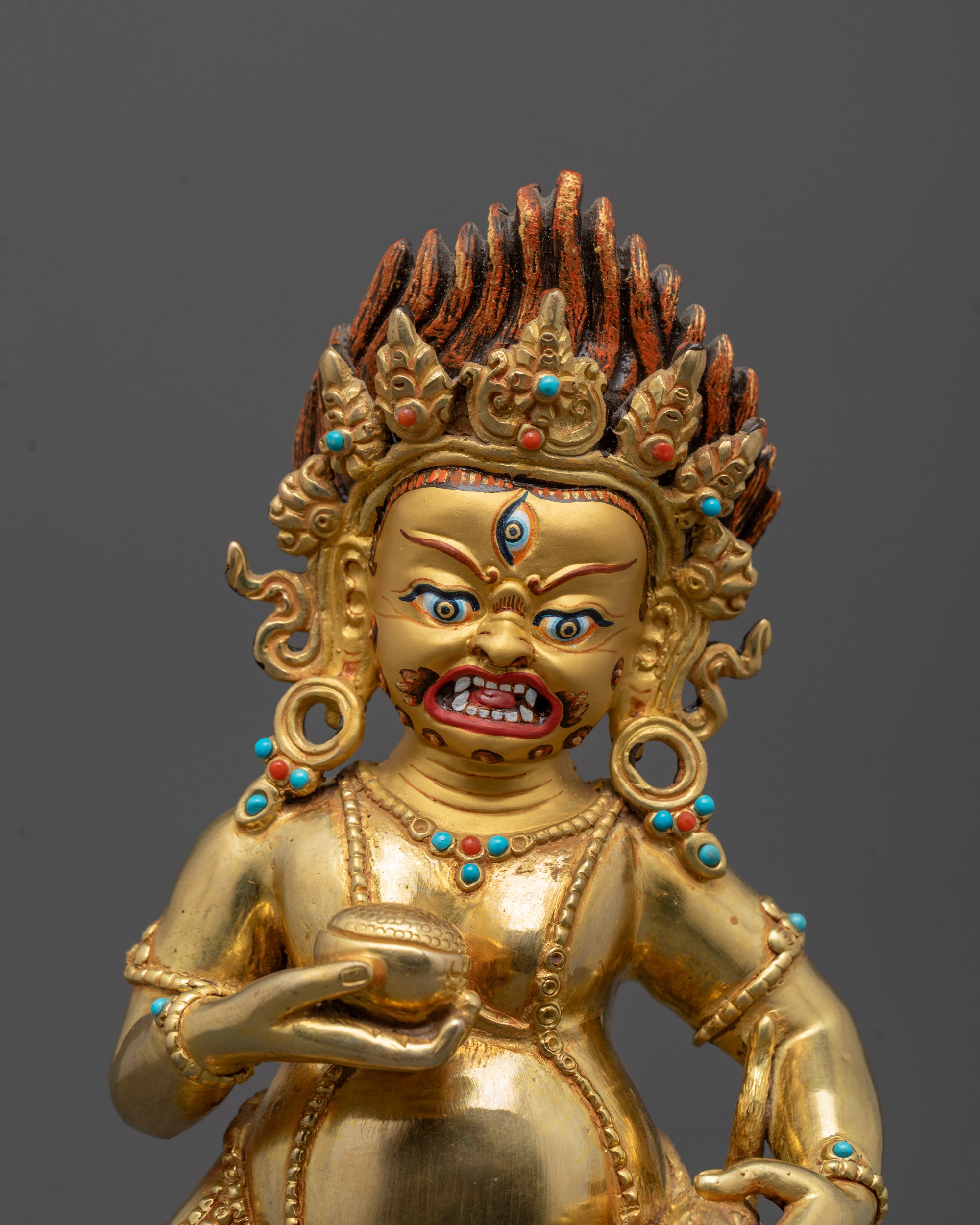 Close-Up of 24k Gold Face on Black Dzambhala Statue
