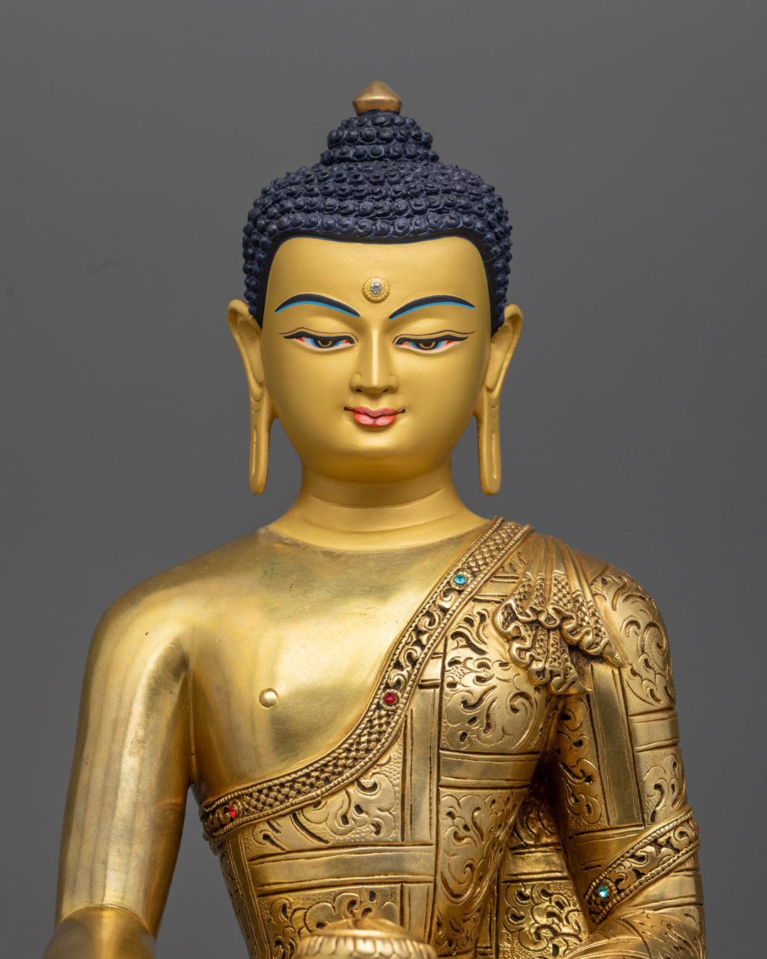 Nepali Shakyamuni Buddha statue with inlaid turquoise stones and symbolic Bhumisparsha mudra.