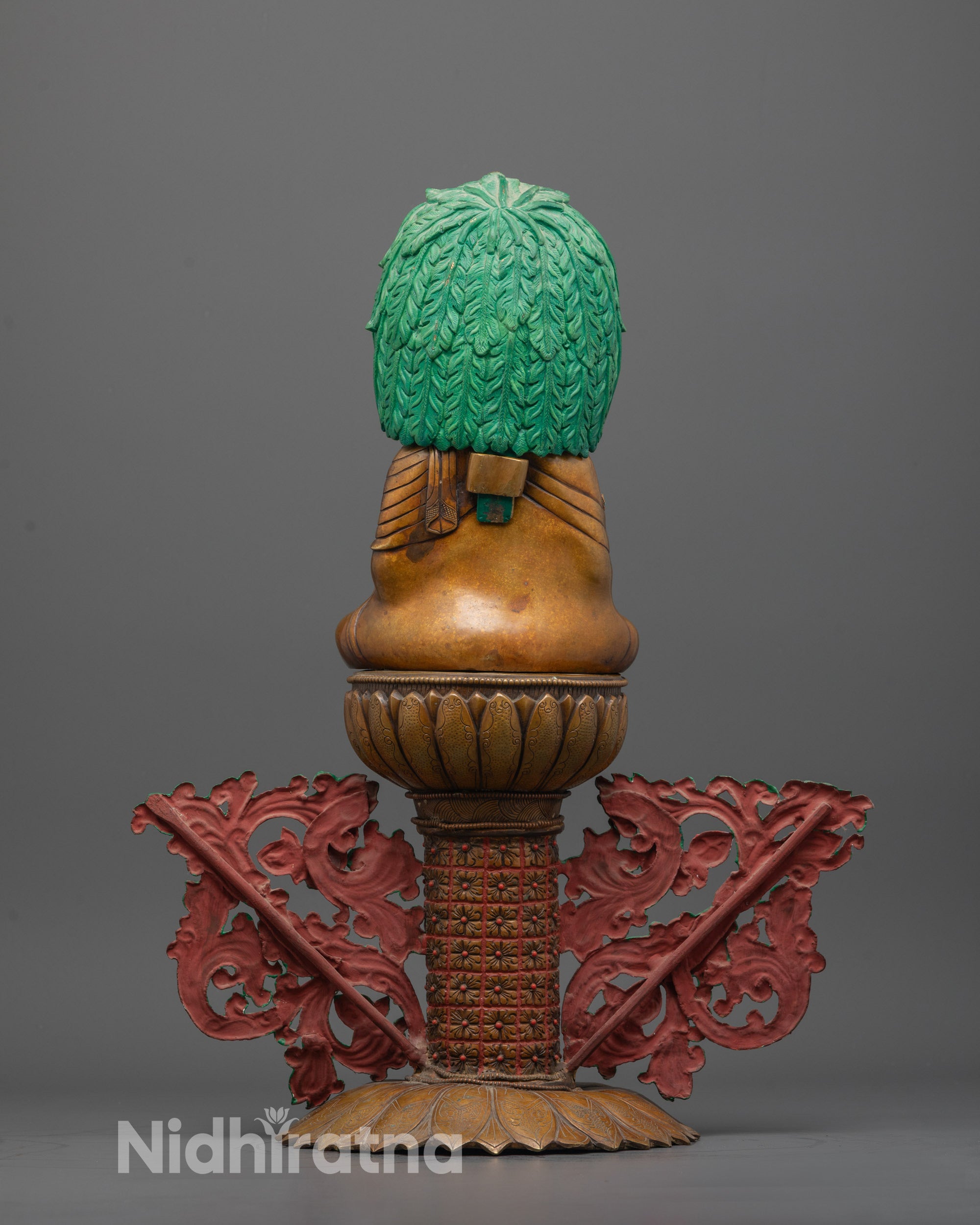 Back view of Mitrugpa statue highlighting painted acrylic colors and oxidized copper finish
