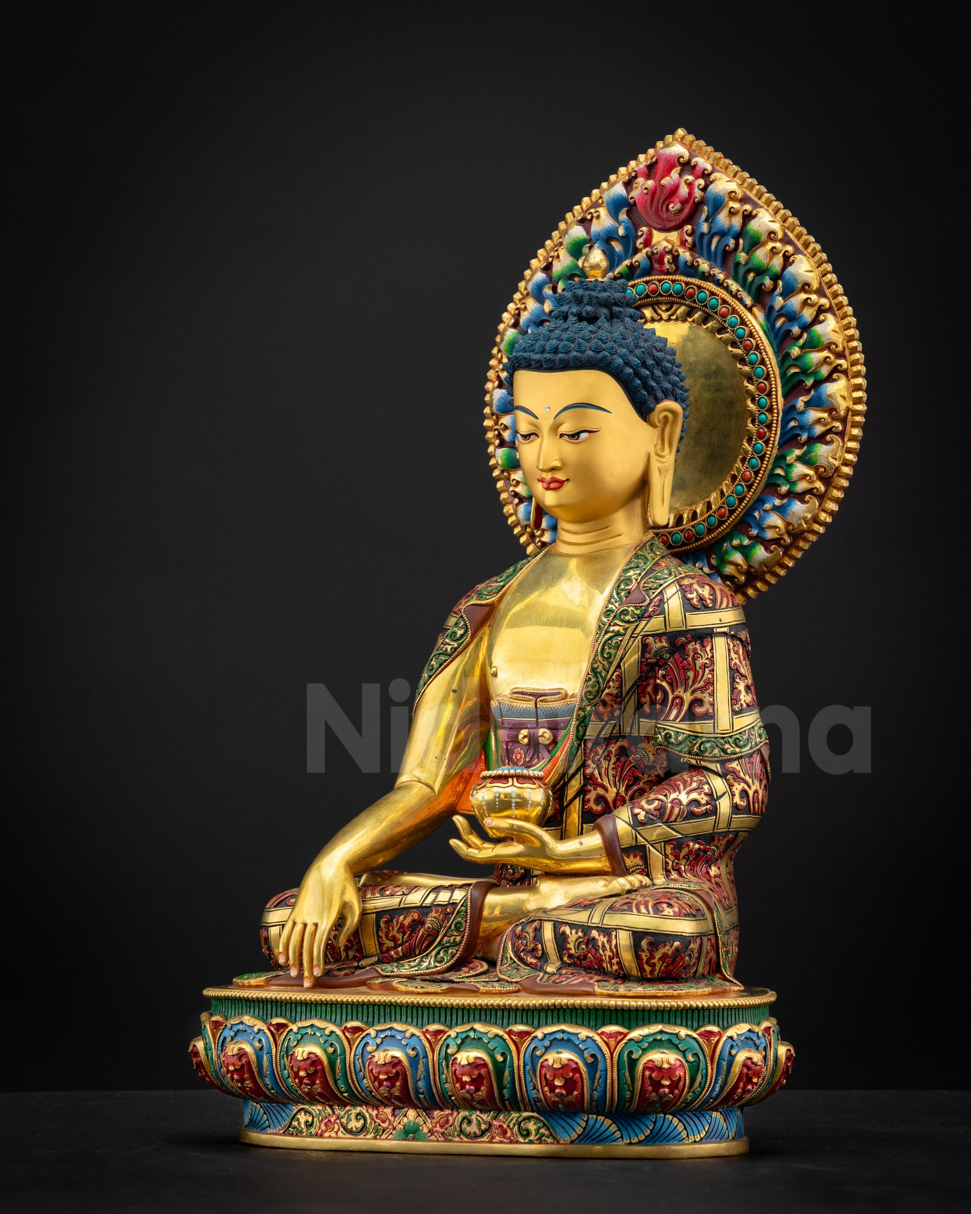 Left side view of Shakyamuni Buddha Statue featuring multi-colored lotus seat and intricate hand-painted details