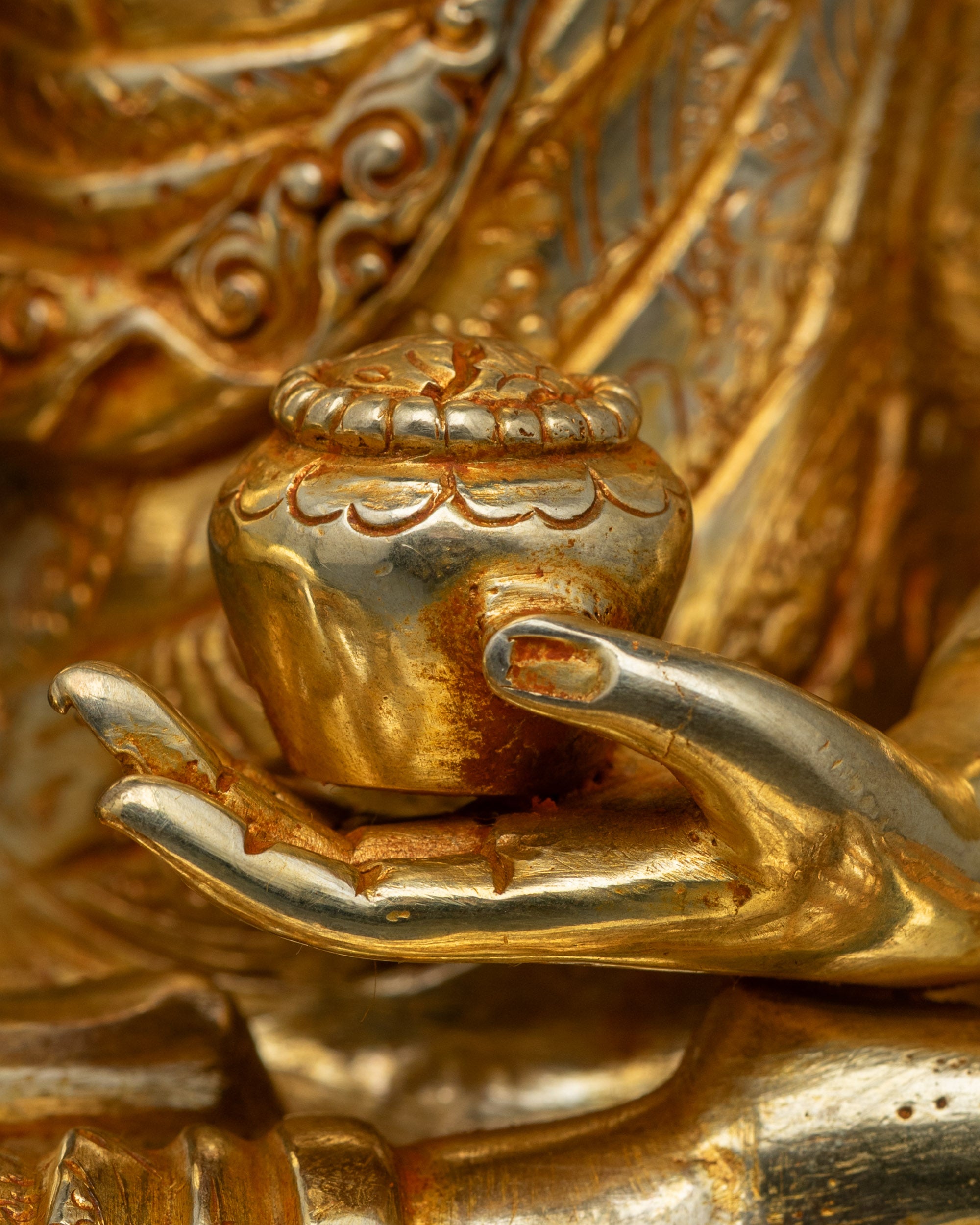 Buddha holding monk’s bowl, seated on lotus throne, traditional Newari lost-wax sculpture