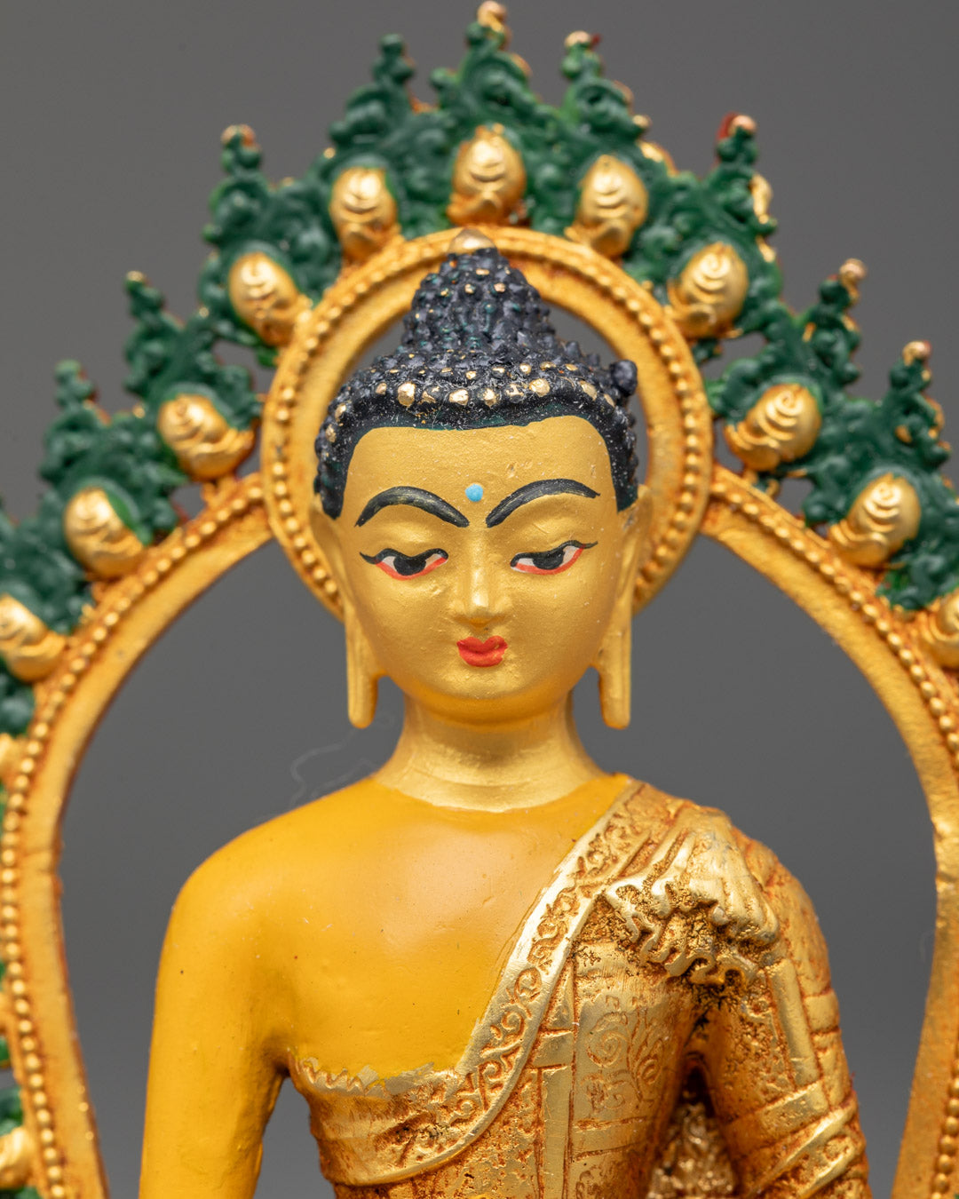 Buddha statue's gold-plated face and hand-painted acrylic halo with intricate detailing