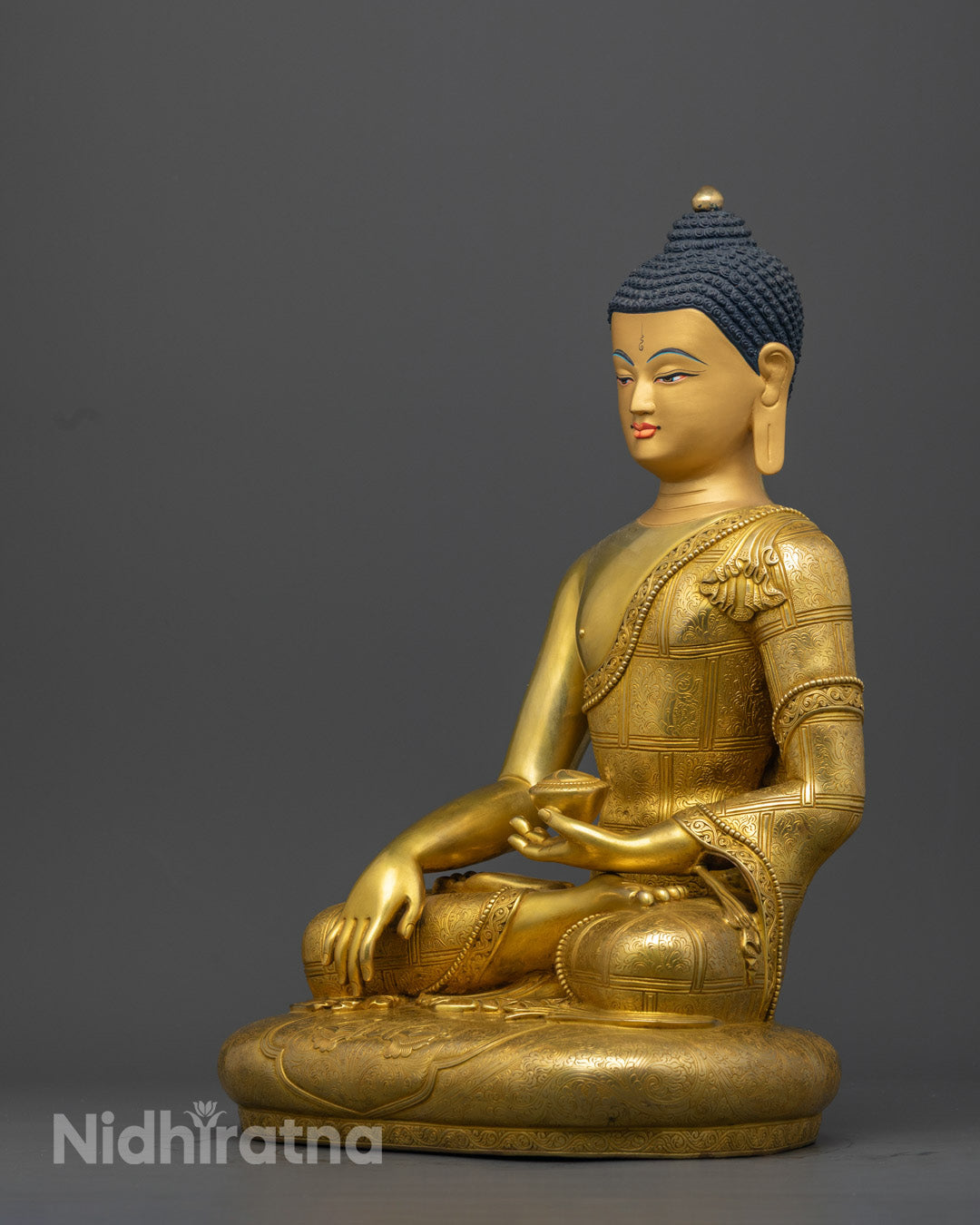 Shakyamuni Buddha statue showing serene expression, intricate craftsmanship, and symbolic Bhumisparsha mudra.