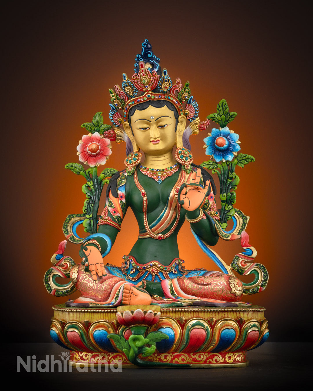 Hand-carved Green Tara statue with 24k gold-plated face, semi-precious stones, and vibrant acrylic colors seated in lotus position.