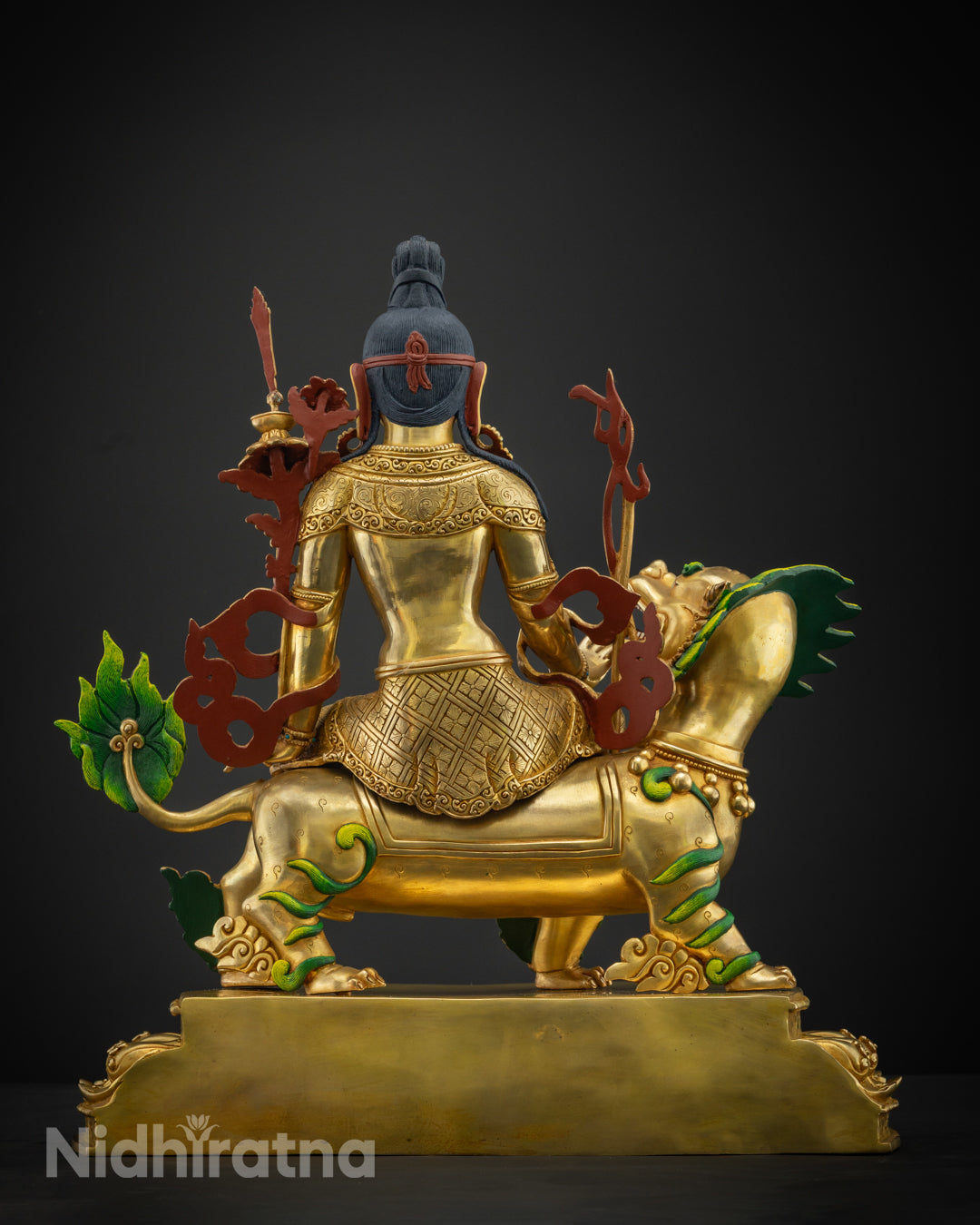 Chenrezig statue showcasing the detailed patterns and hand-hammered textures on the copper surface.