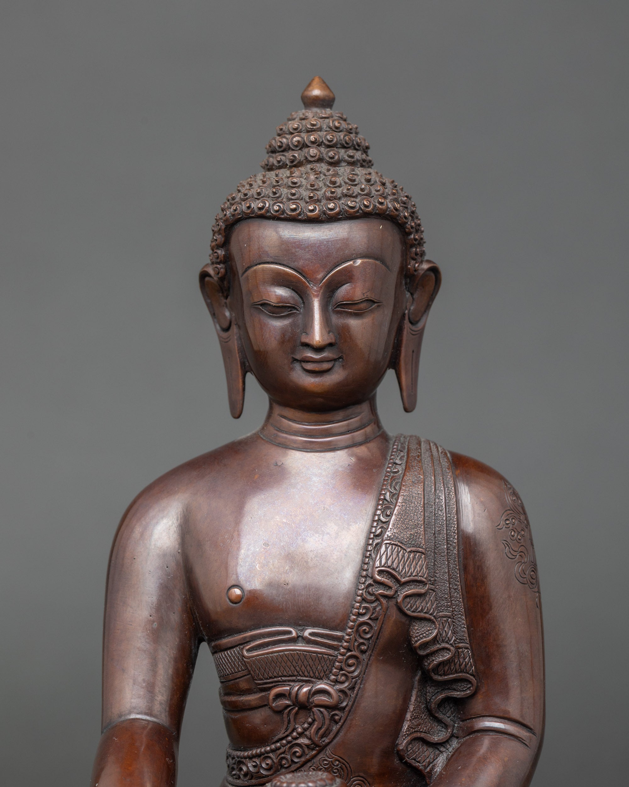Chemically oxidized Shakyamuni Buddha holding a monk’s alms bowl on lotus throne