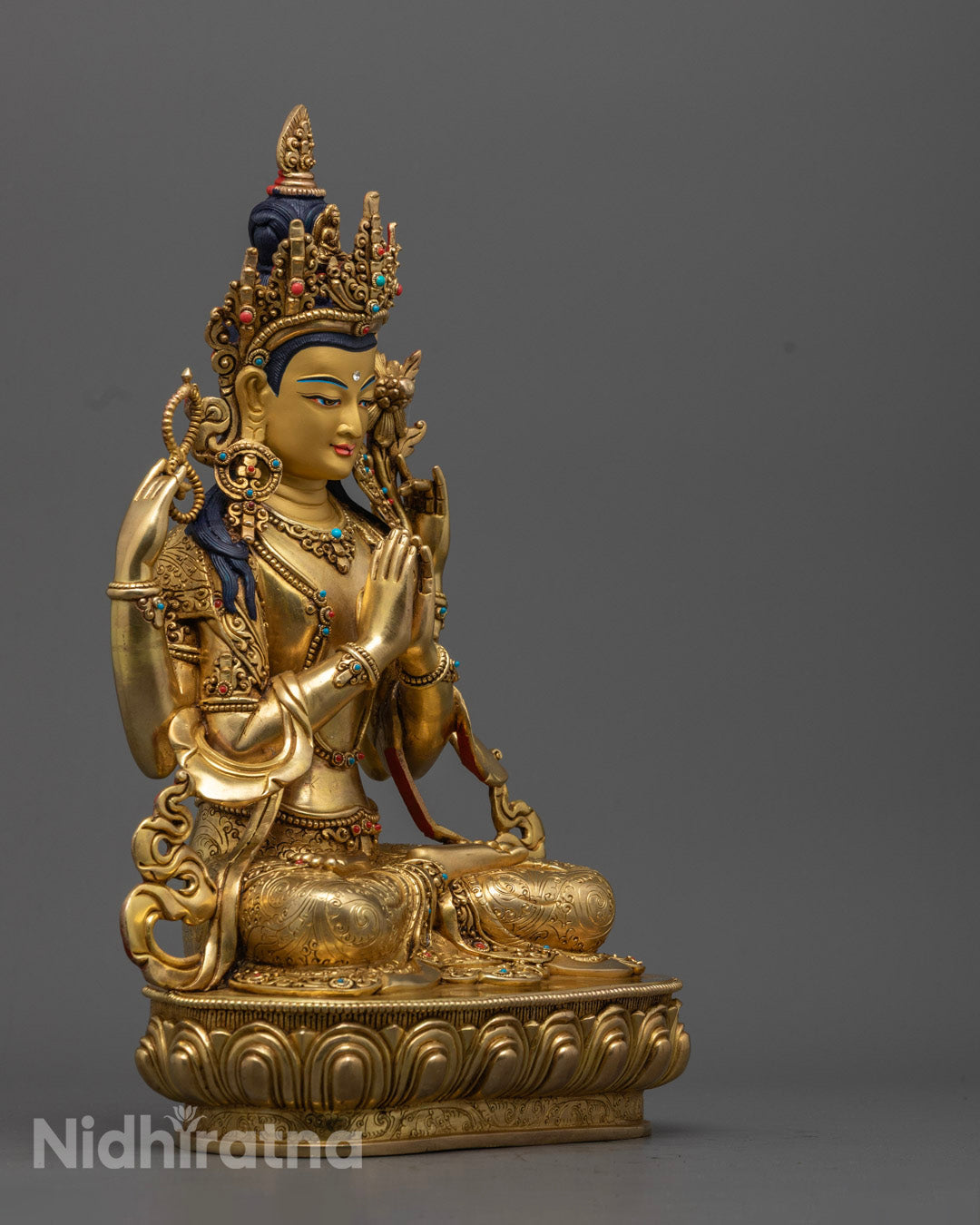 Chenrezig statue from Nepal, 24K gold gilded Bodhisattva of Compassion with lotus, mala, and jewel in four arms.