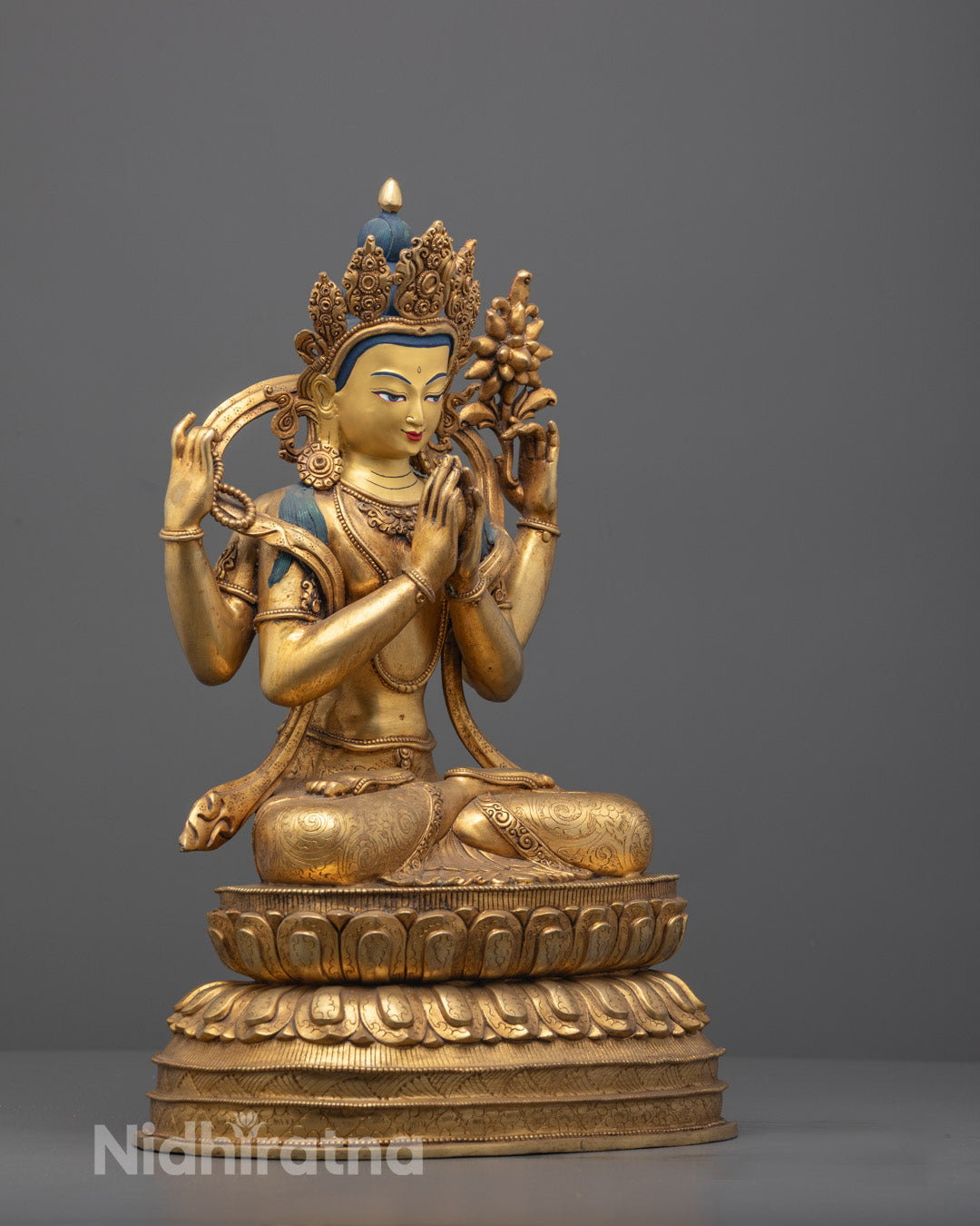 Left angle of Chenrezig showing mala and detailed floating robe carvings