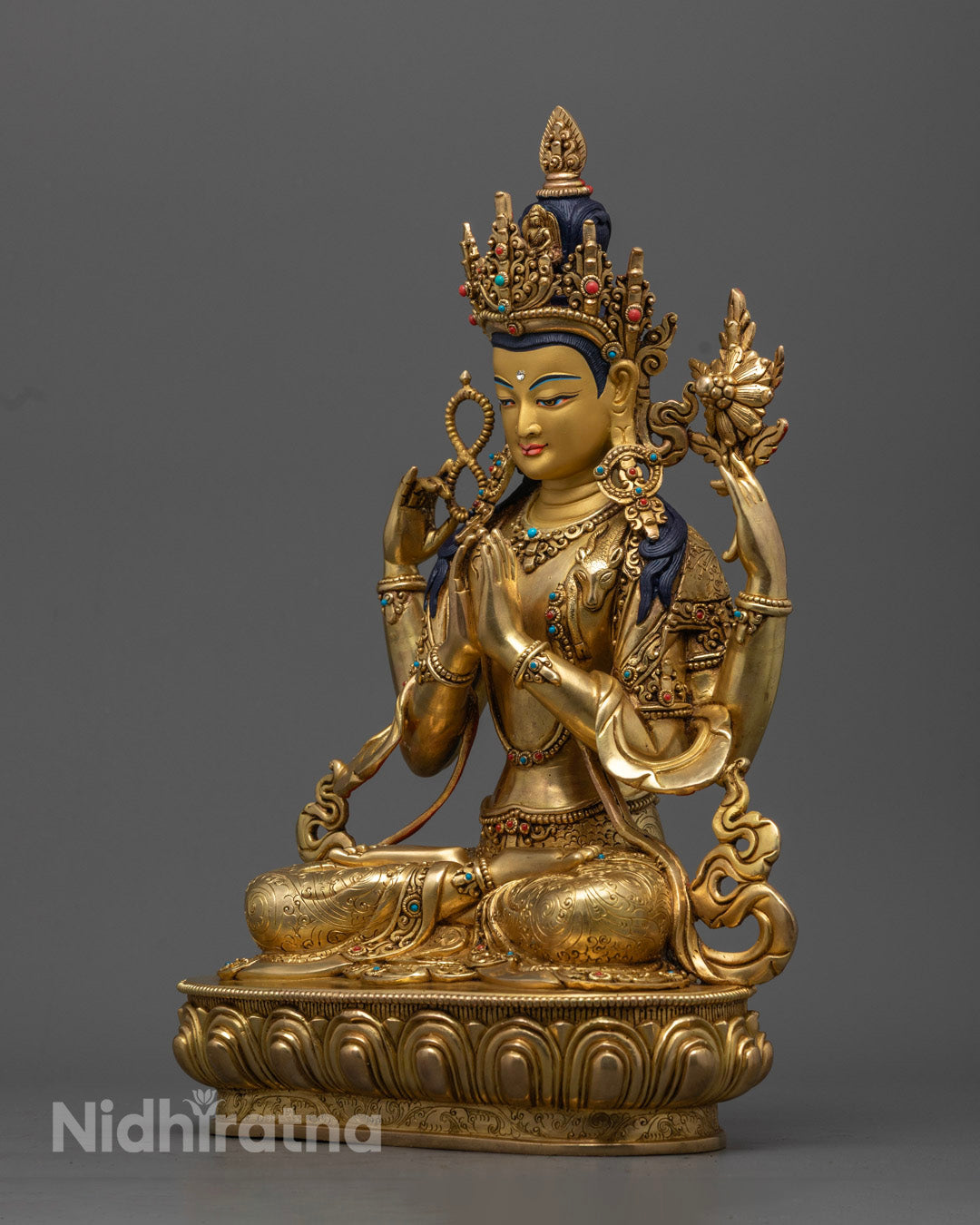 Handcrafted Avalokiteshvara statue, Tibetan Buddhist deity in copper and gold with semi-precious stone inlays.
