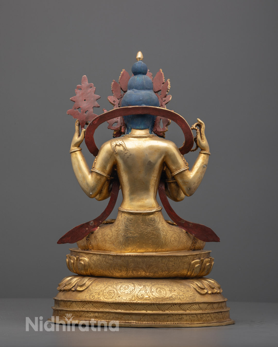 Back view of Chenrezig statue with ornate lower garment and mantra chamber base