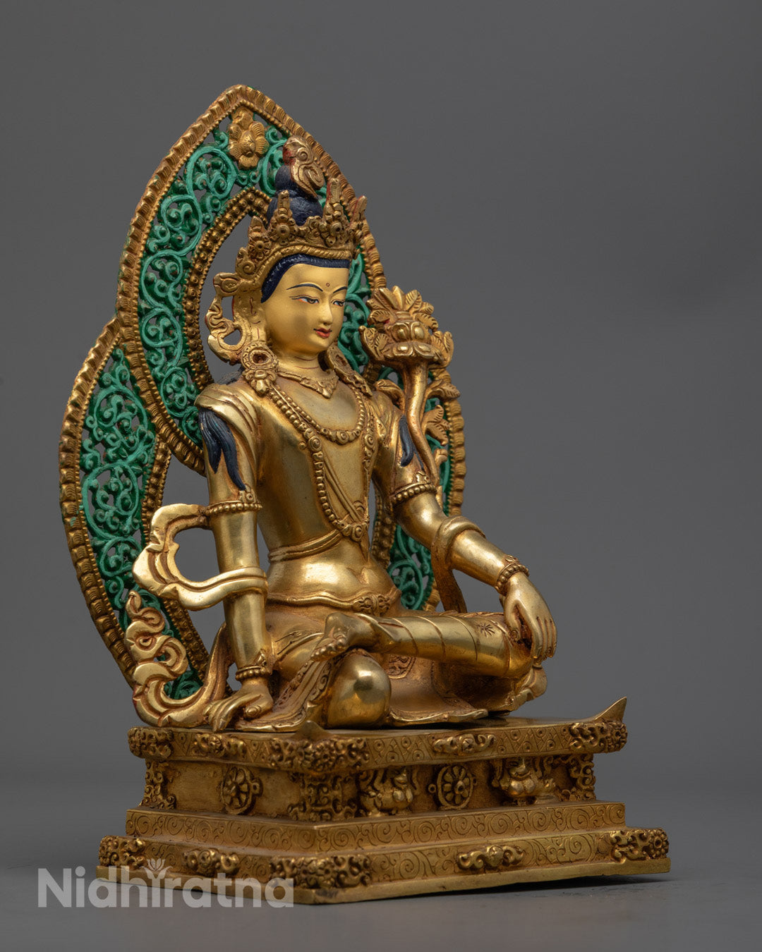 Chenrezig statue seated gracefully on a lotus throne symbolizing compassion and spiritual awakening