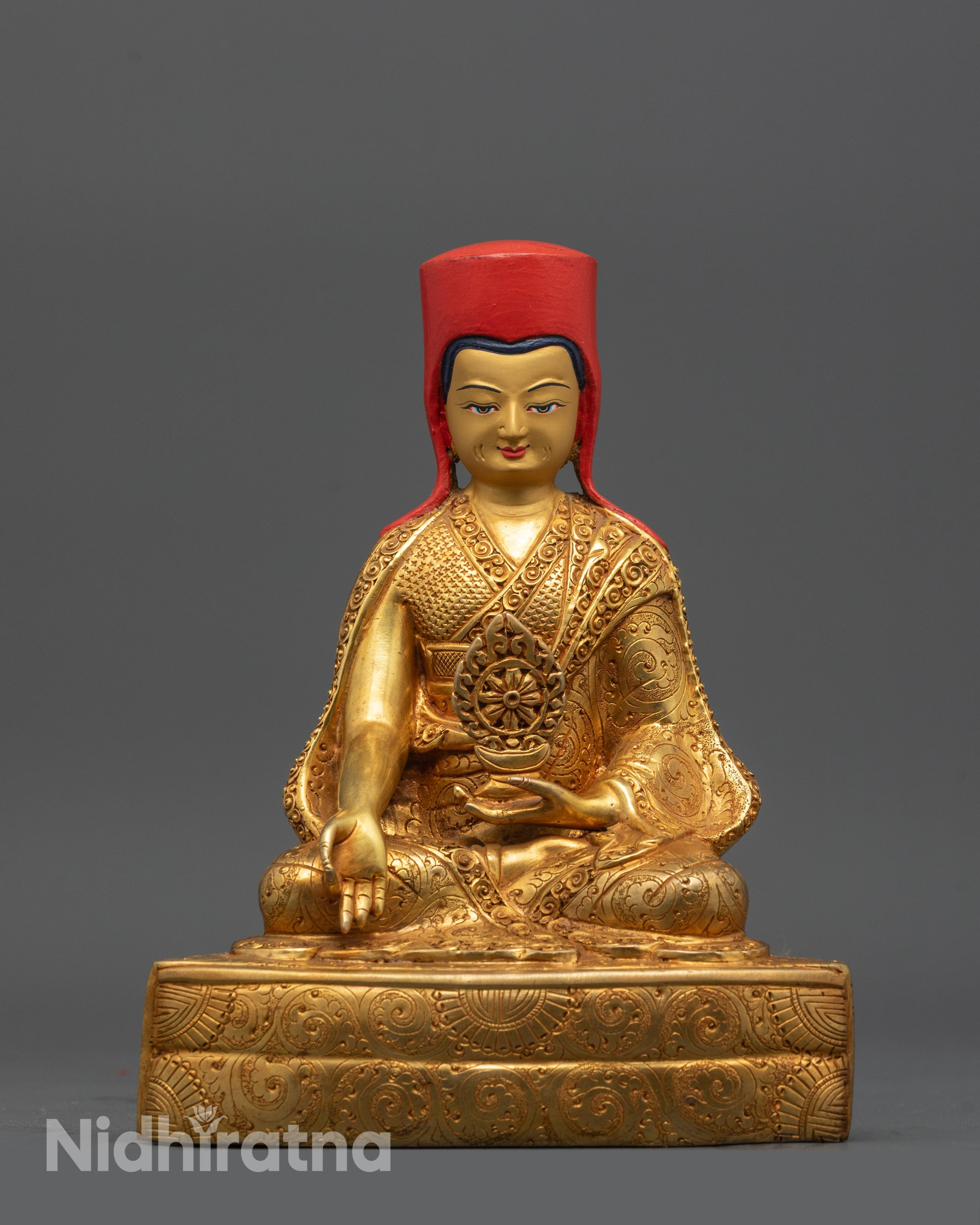 Chogyal Phagpa holding dharma wheel, serene gold-plated Sakya master statue