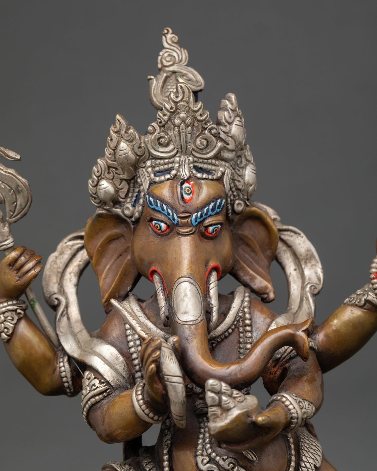 Close-up of handcrafted Ganesha statue with silver plating and intricate Newari carvings