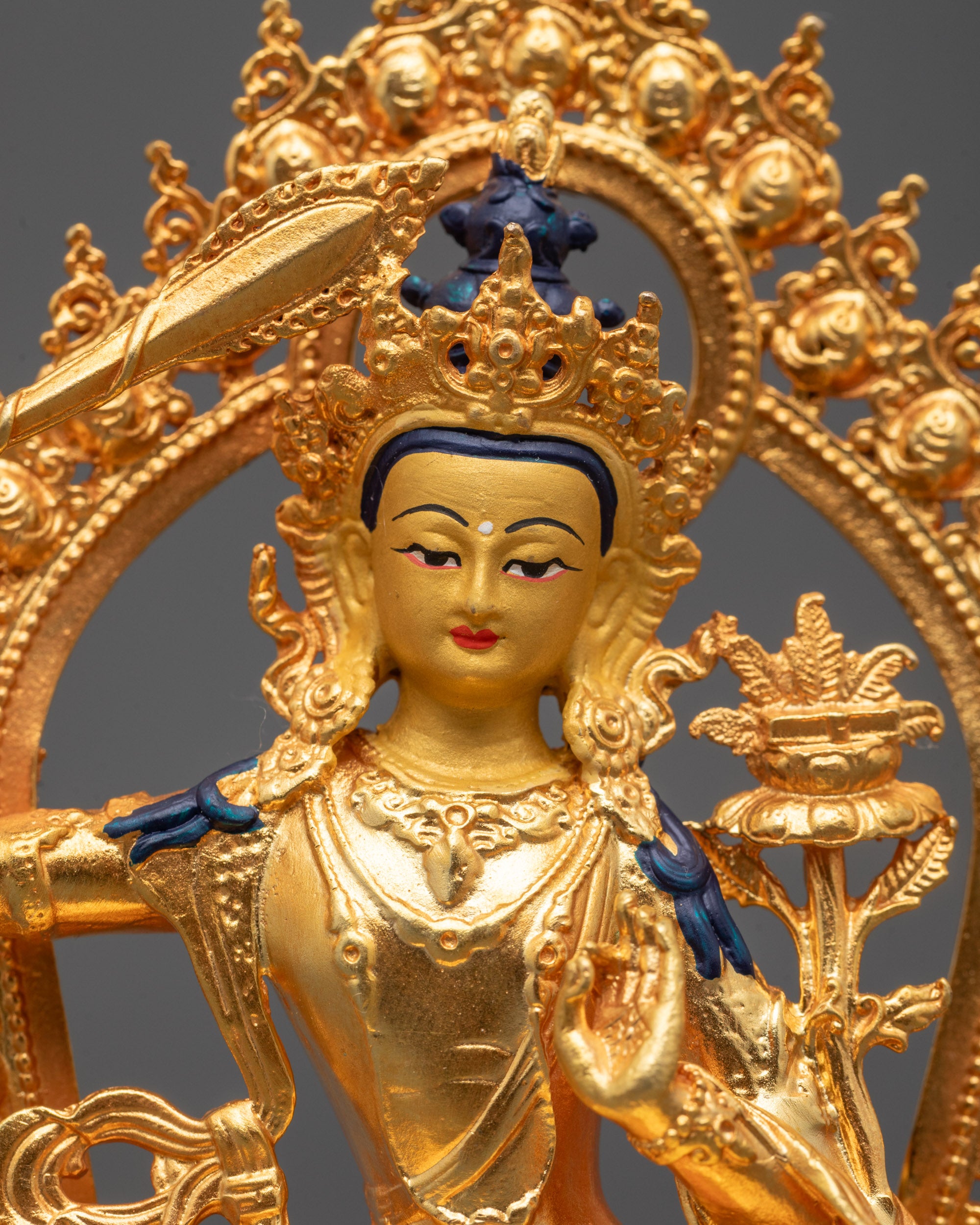 Close-Up of Manjushri Buddha Sculpture Holding Flaming Sword