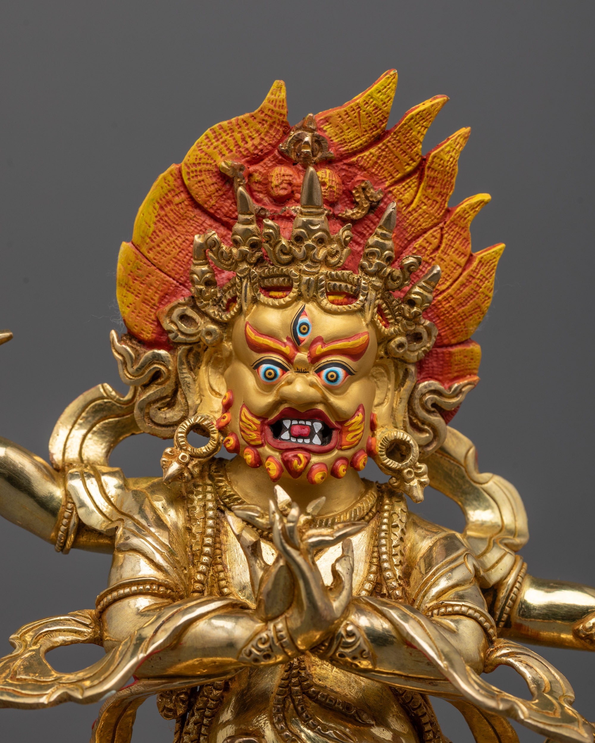Close-Up of Vajrapani Statue Face with Vajra and Intricate Gold Detailing