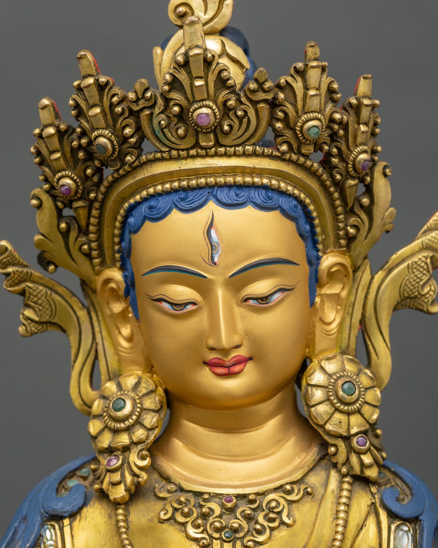 Close-up Dukar statue showing 24K gold gilded copper and intricate details