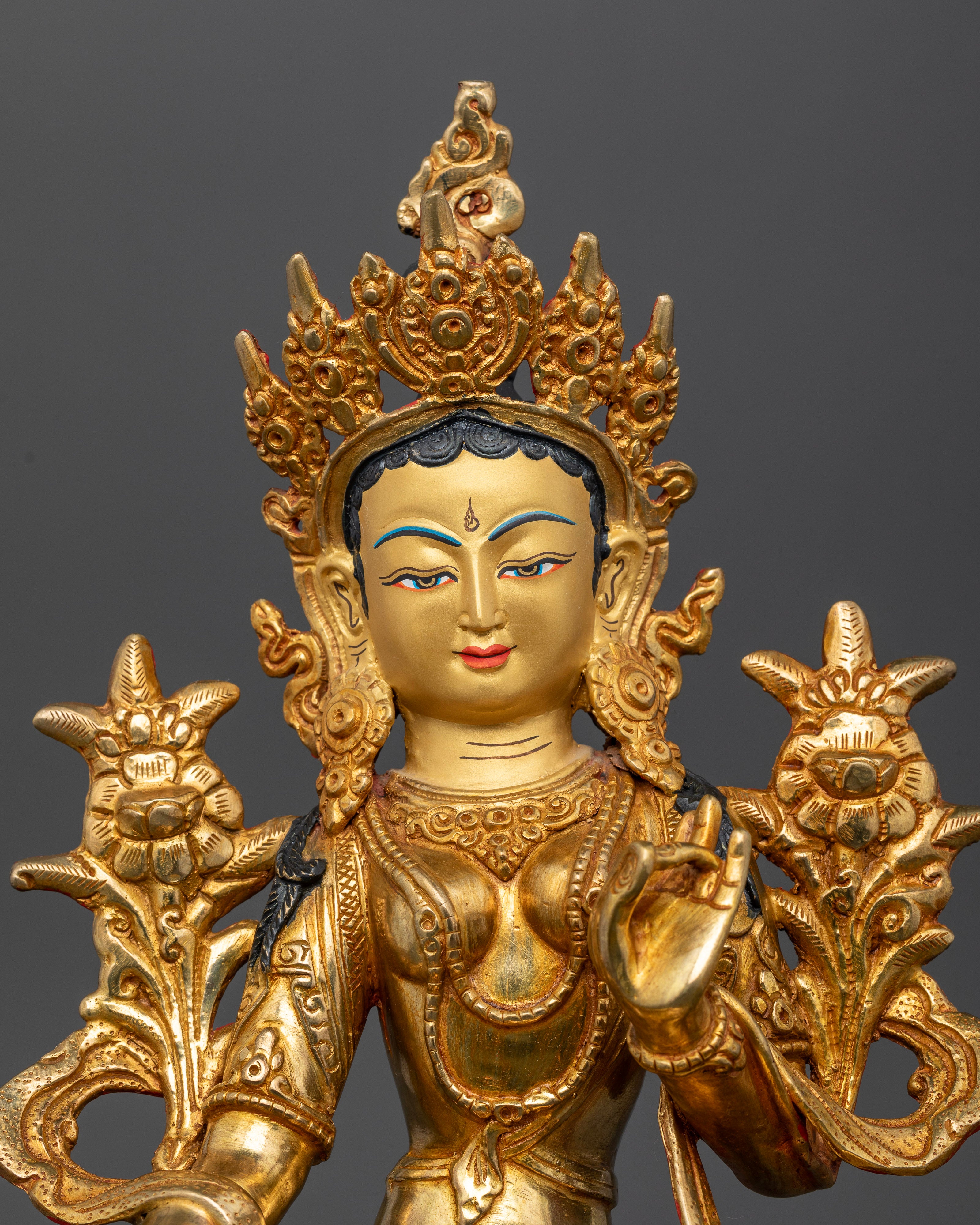 Close up Green Tara face gold painted copper Buddhist goddess handcrafted in Nepal