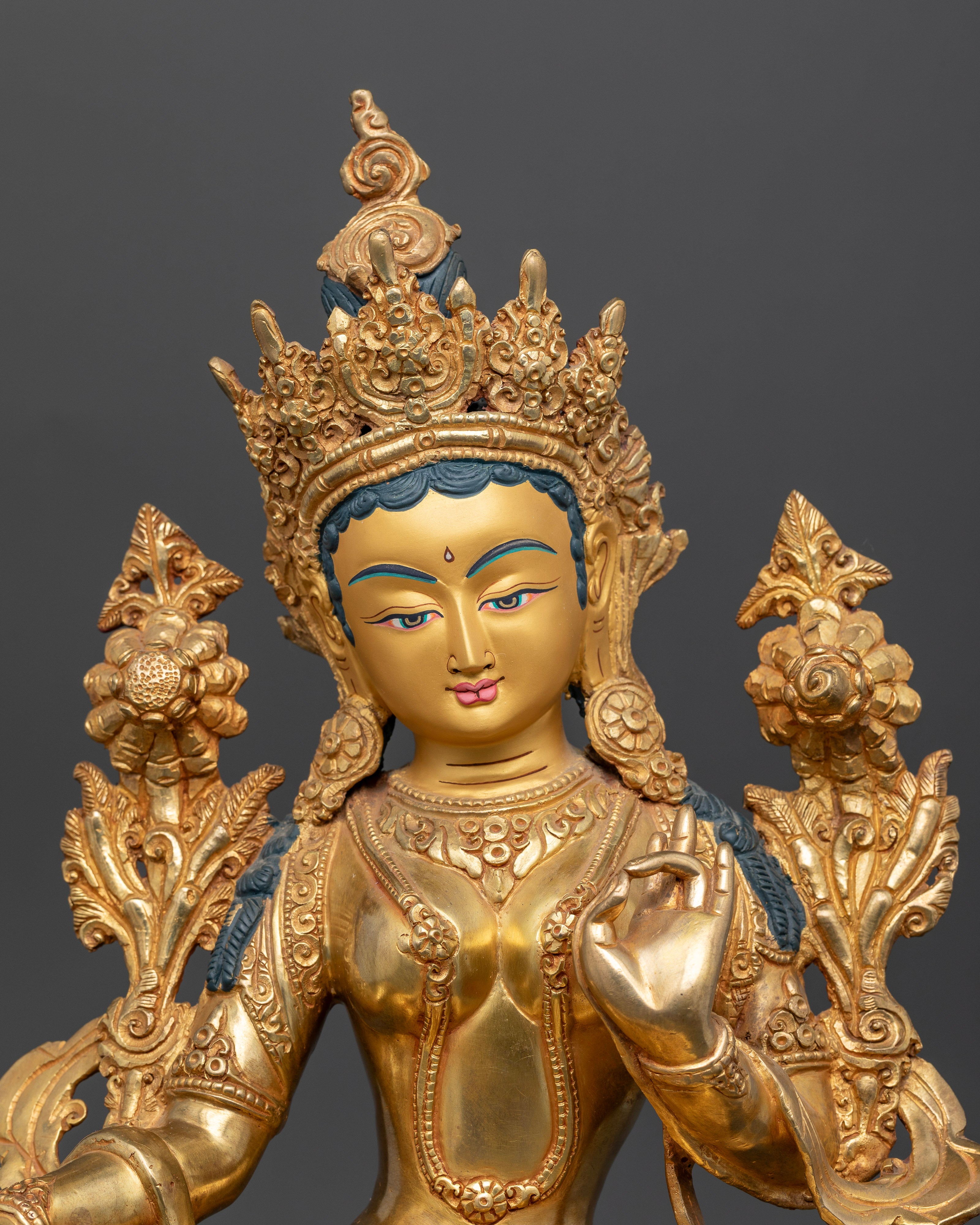 Close up Green Tara face gold-painted copper Buddhist goddess