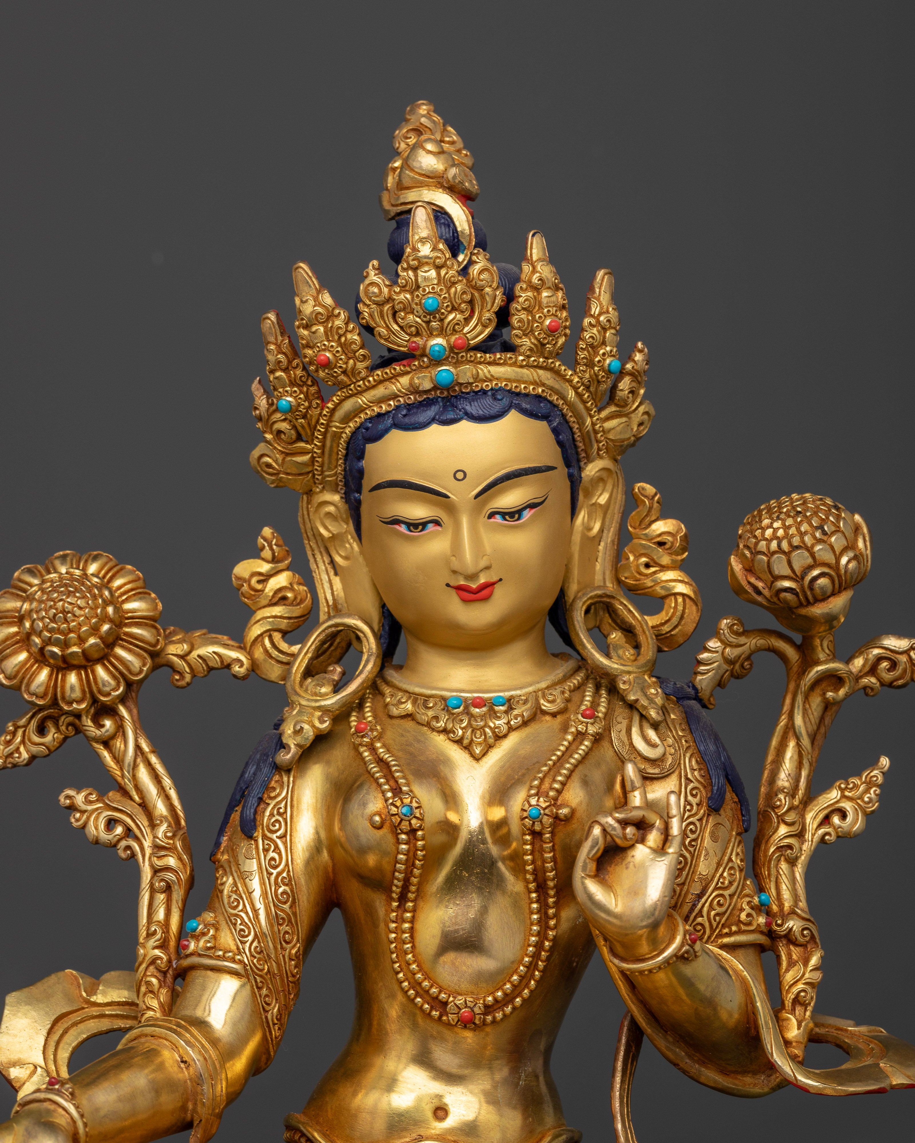 Close up Green Tara sculpture Varada Mudra Vitarka Mudra Utpala flower Buddhist deity
