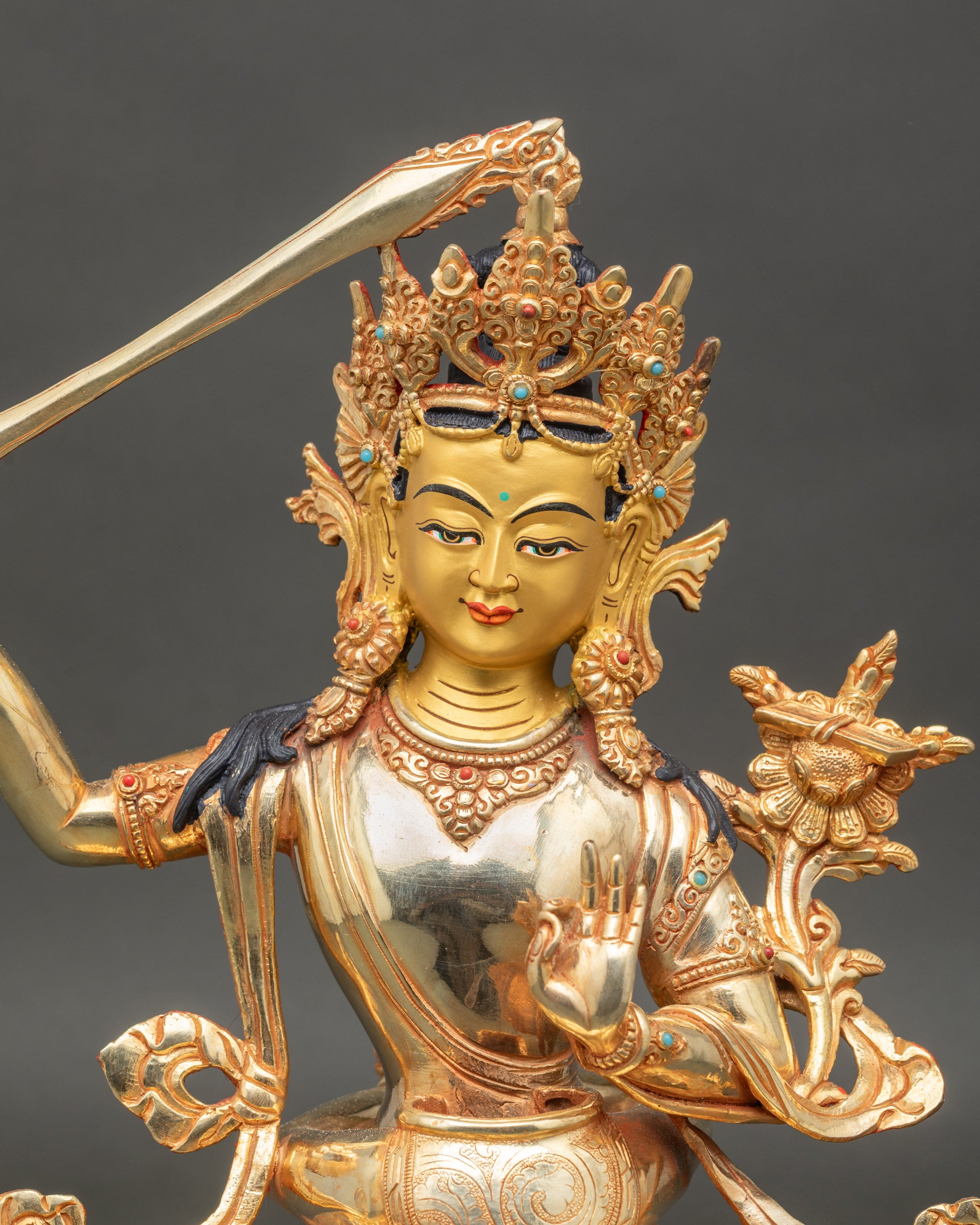 Close-up-Manjushri-face-consort-gold-copper-statue-semi-precious-stones-intricate-robes