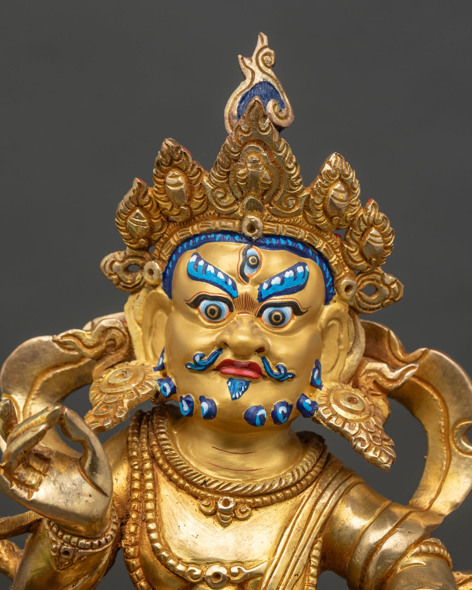 Close up Namtoshe statue gold-painted face hand-painted acrylic details Himalayan art