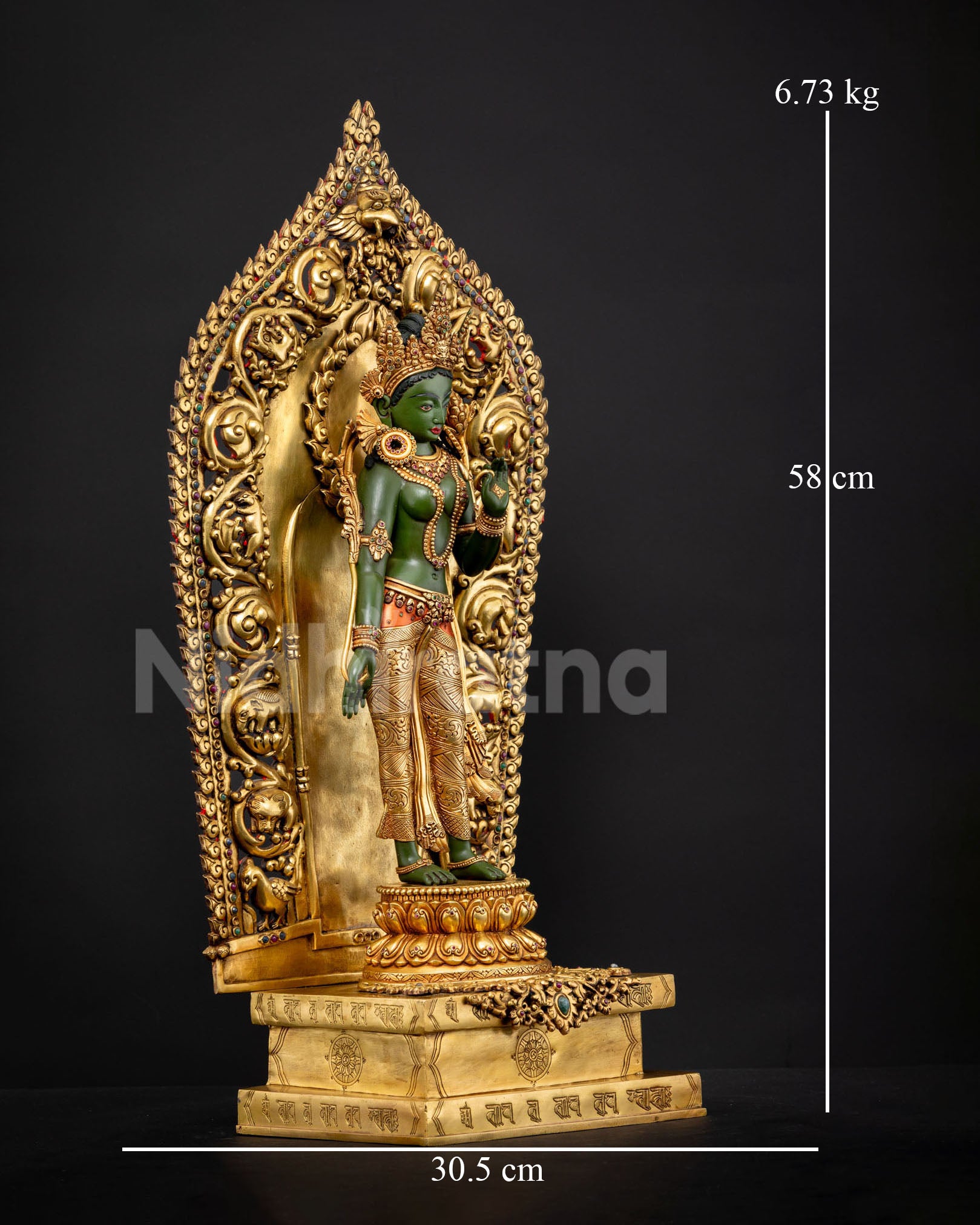 Close up of Green Tara statue genuine Nepali Buddhist art gold gilded copper sculpture adorned with gemstones