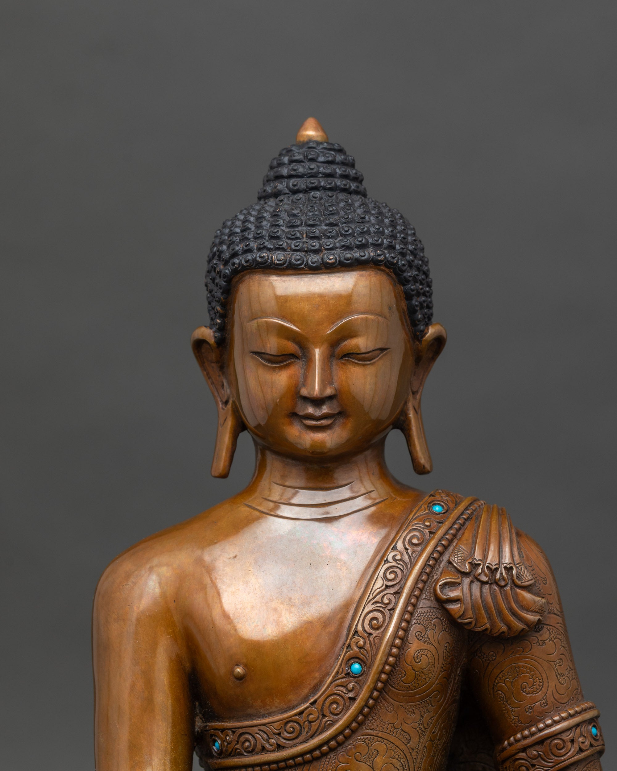 Close-up of Ratnasambhava Buddha statue showing intricate jewel vase and serene expression