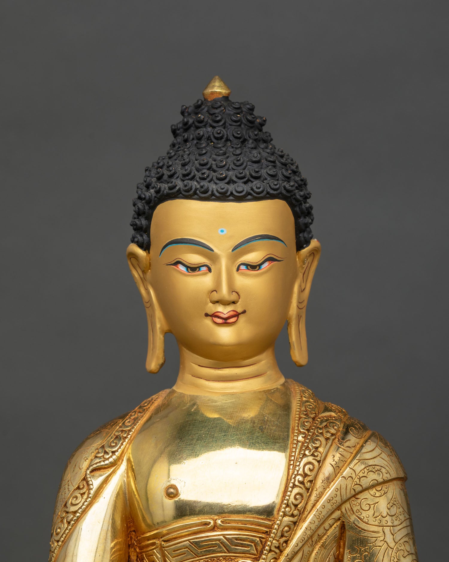 Close up of Shakyamuni Buddha Statue gold-painted face ornate halo relief carvings sacred bowl