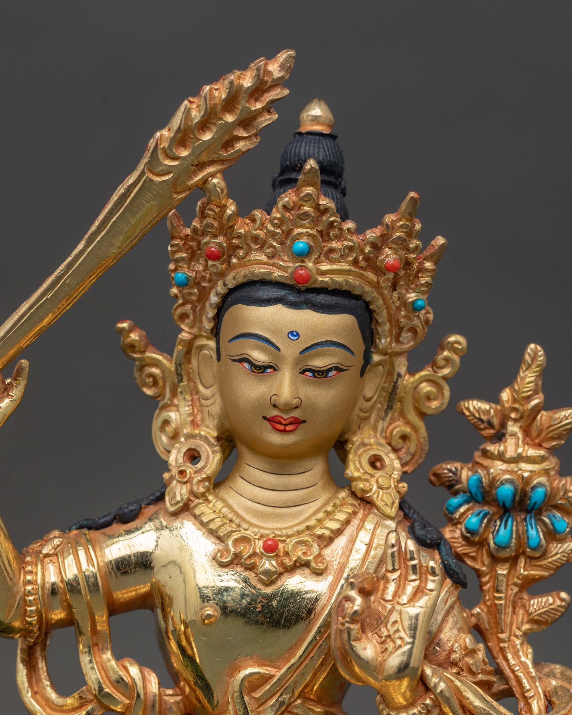 Close-up of Simhada Manjushri statue showing intricate copper and gold craftsmanship