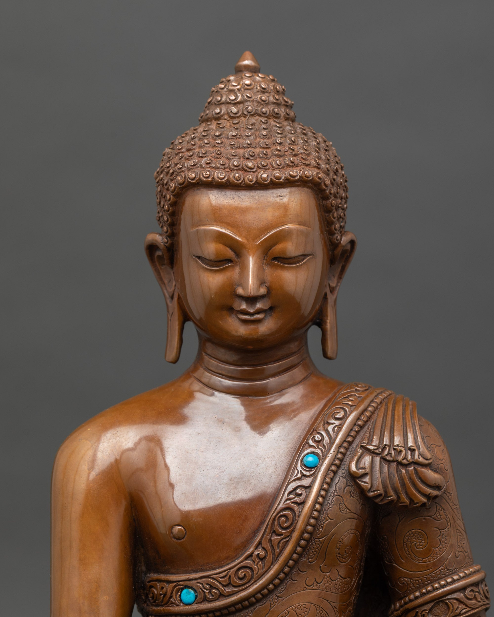 Close-up-of-serene-Medicine-Buddha-face-with-intricate-copper-details-and-oxidized-finish