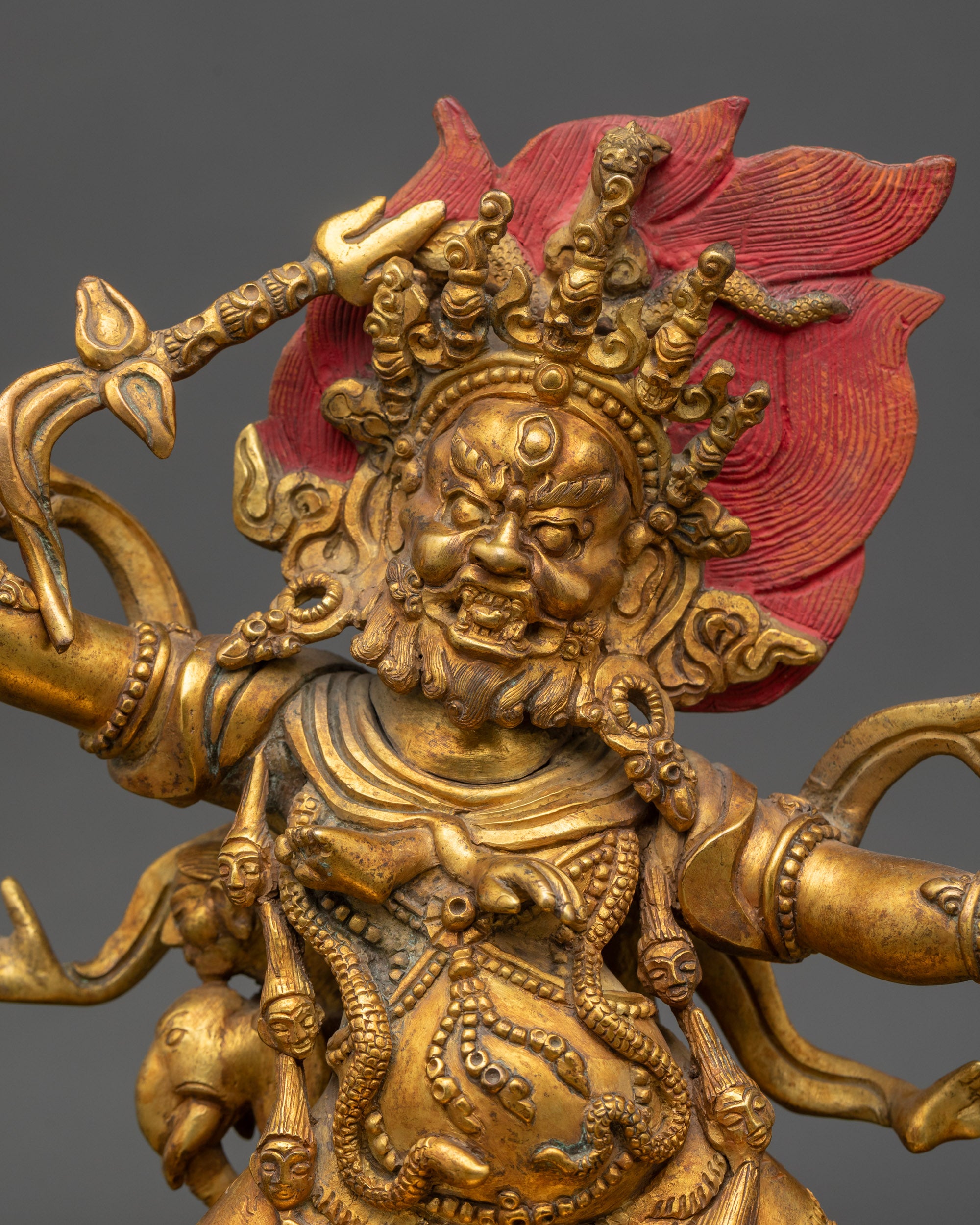Close-up Hayagriva face gold-painted finish, fierce expression, Himalayan Buddhist art