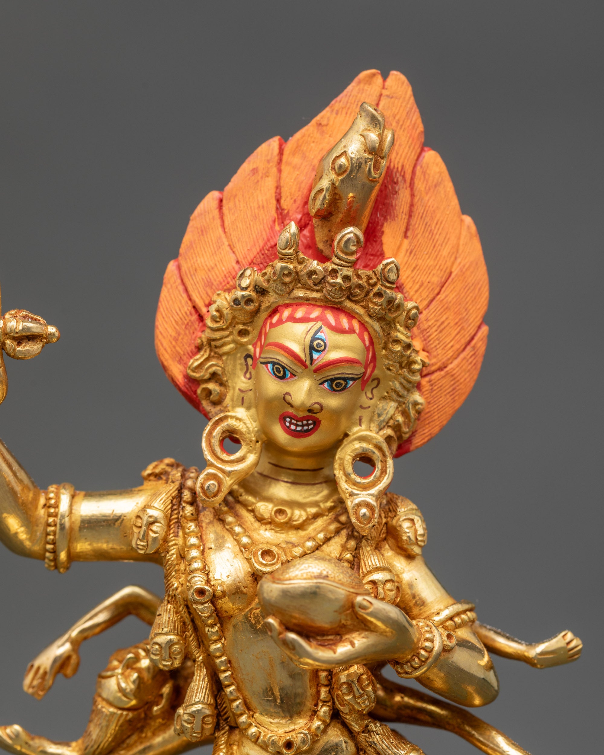 Close-up Troma Nagmo face, gold-painted, tantric deity detail