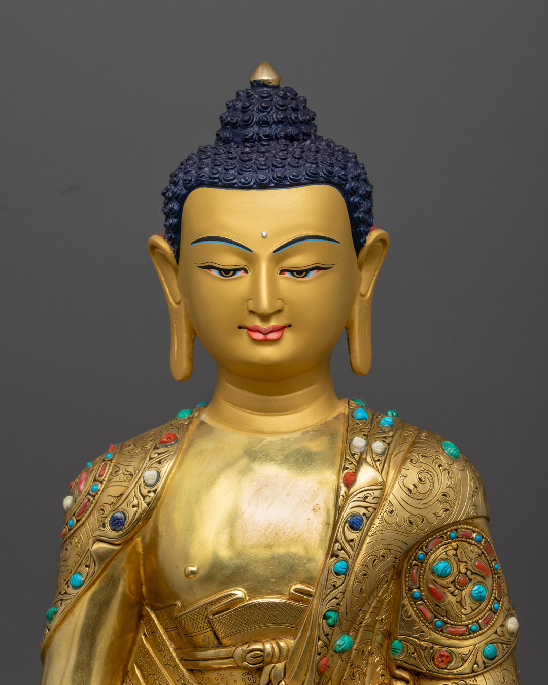 Close-up of Amitabha Buddha’s Serene Face with Intricate Gold Detailing